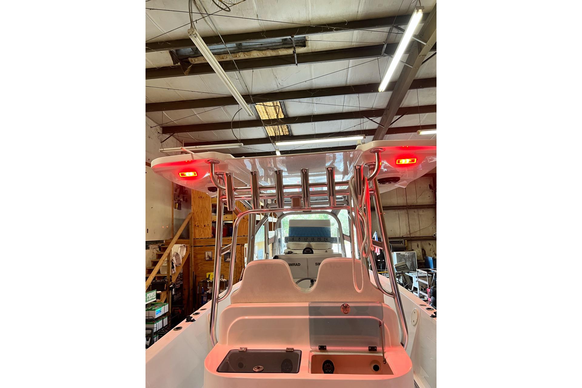 2021 Custom Infusion 34 CC boat interior with red lights in a workshop setting.