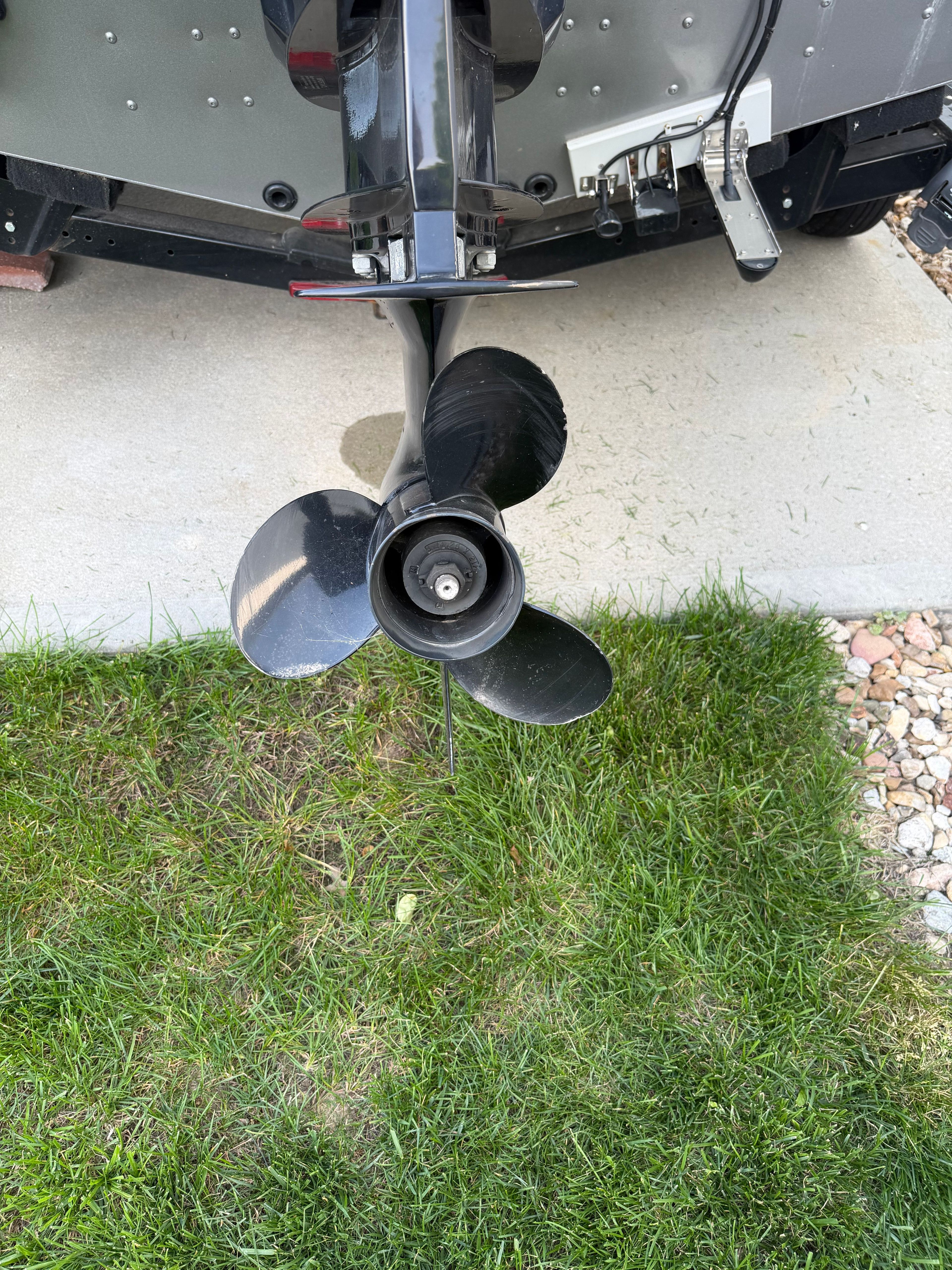 2017 Lund Pro V 1975 boat propeller on grass surface.