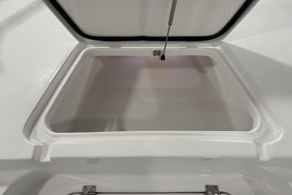 Open storage compartment on 2026 Tidewater 2210 Carolina Bay boat.