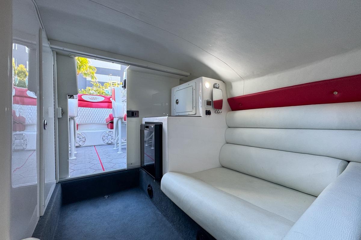 Interior of 2022 Velocity 290sc boat with white seating and modern amenities.