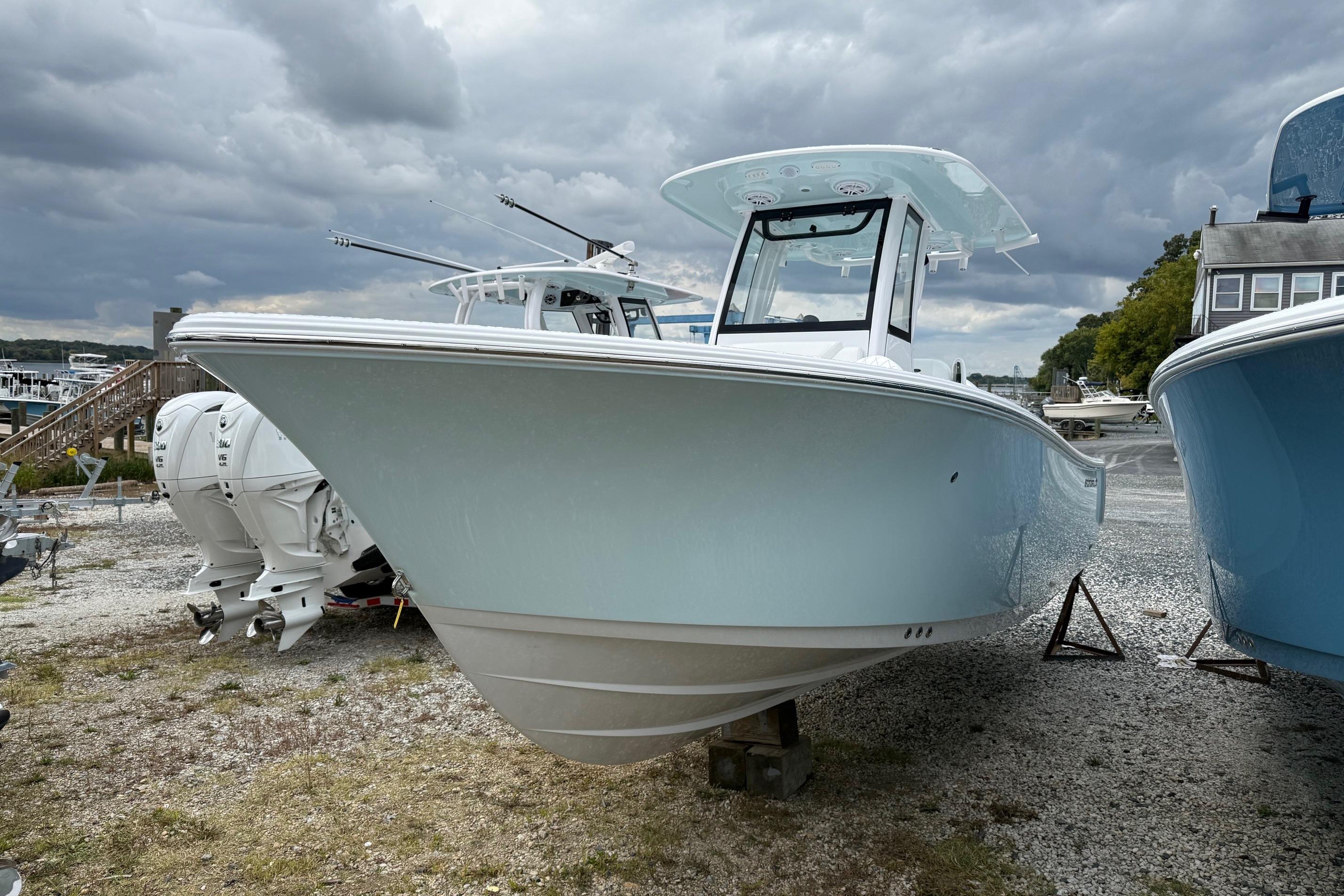 2026 Sportsman Heritage 231 Center Console boat on display under cloudy skies.