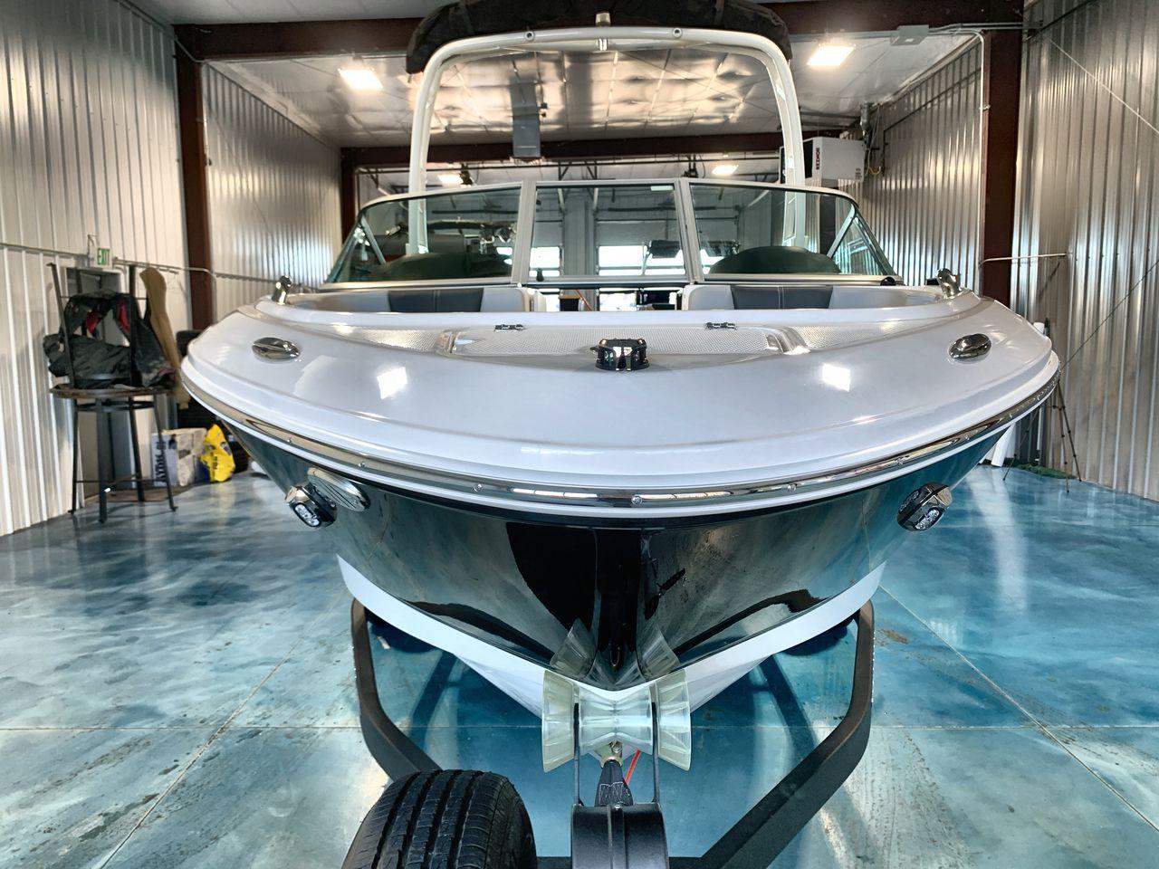 2025 Chaparral 21 SSi boat in a storage facility, front view.