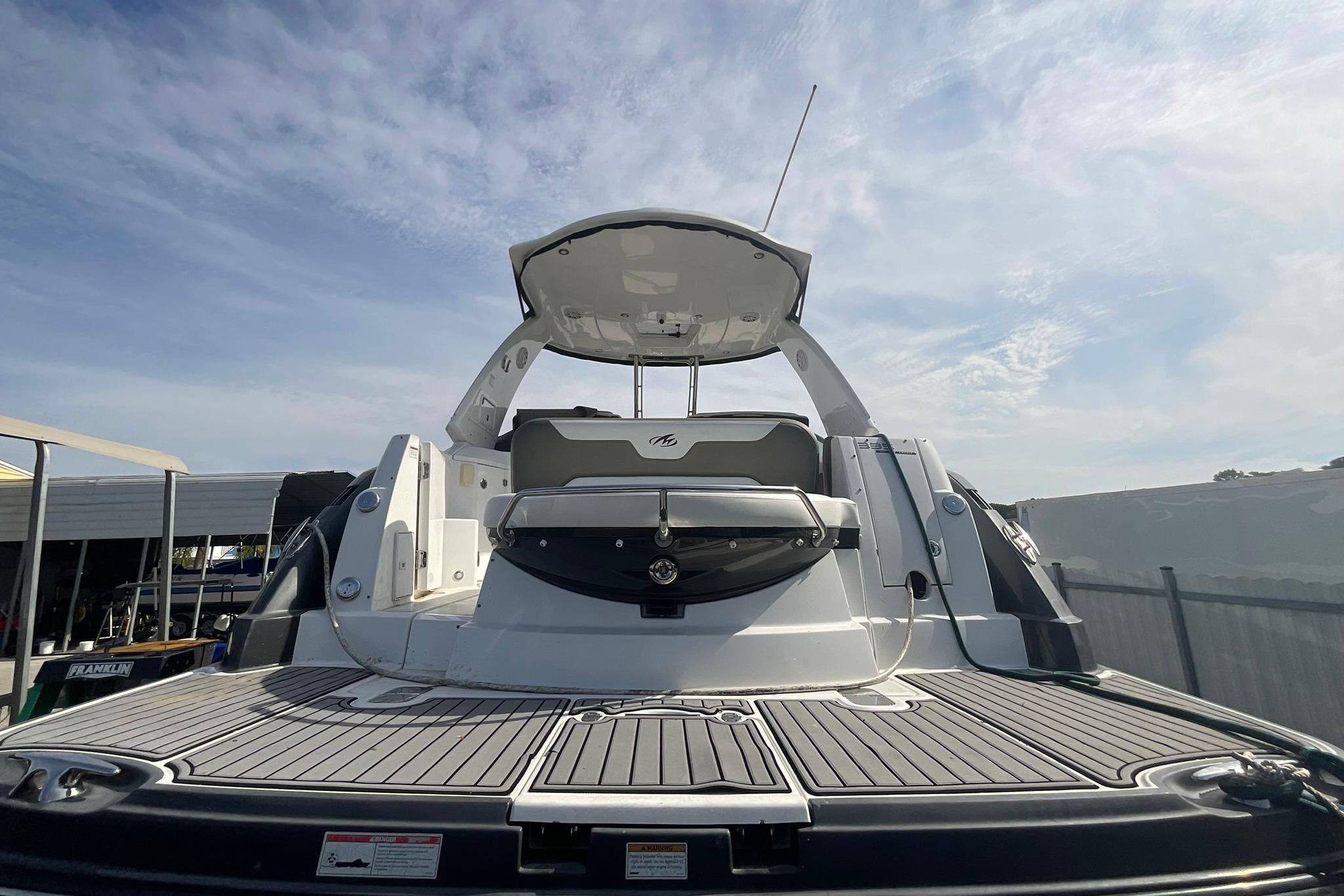 2019 Monterey 335 Sport Yacht with sleek design, spacious deck, and modern features under a clear sky.