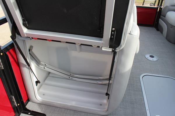2025 Regency 230 DL3 boat interior storage compartment with open seat.