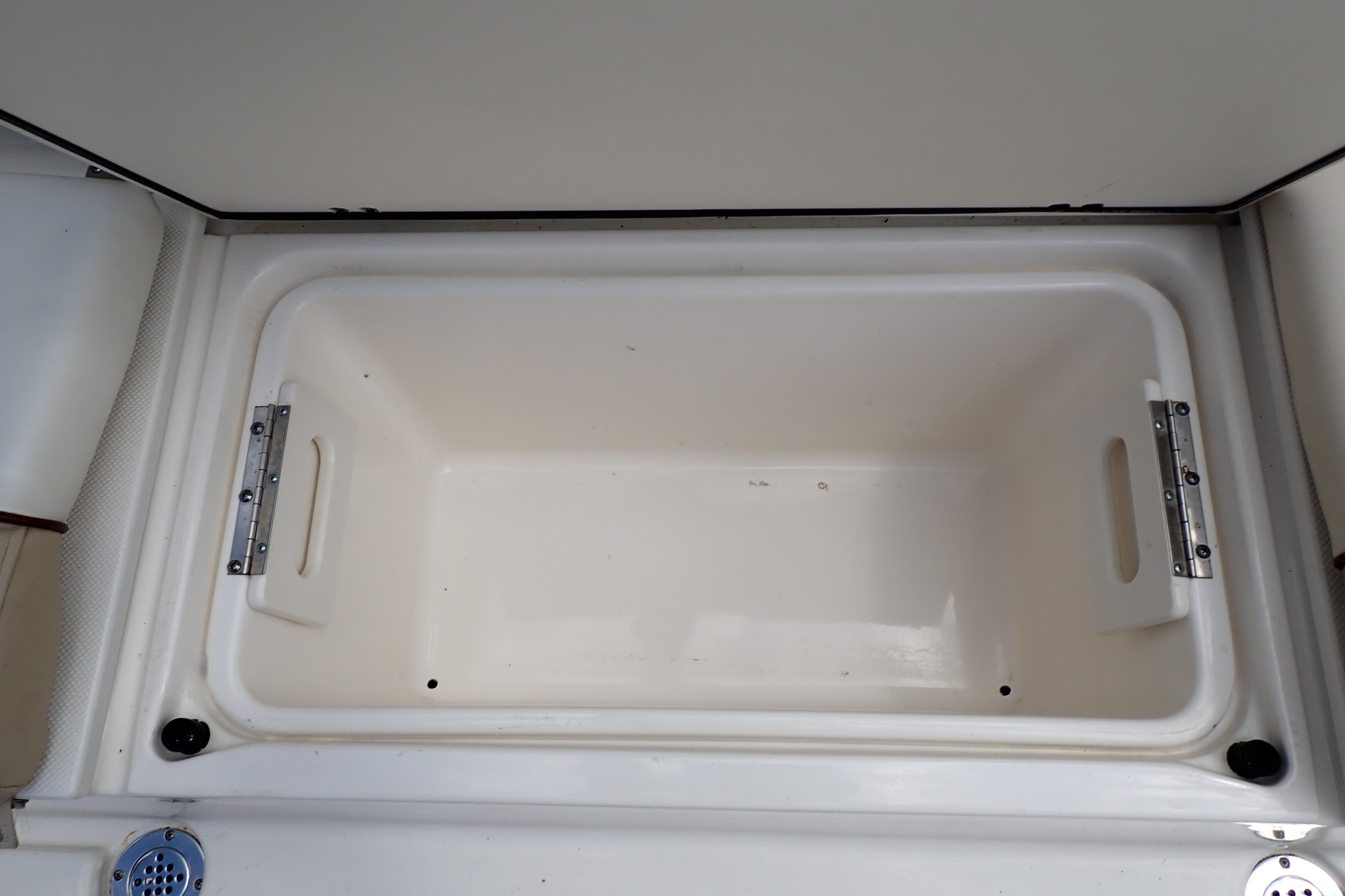 Storage compartment on a 2019 Key West 263 FS boat, featuring a spacious interior.