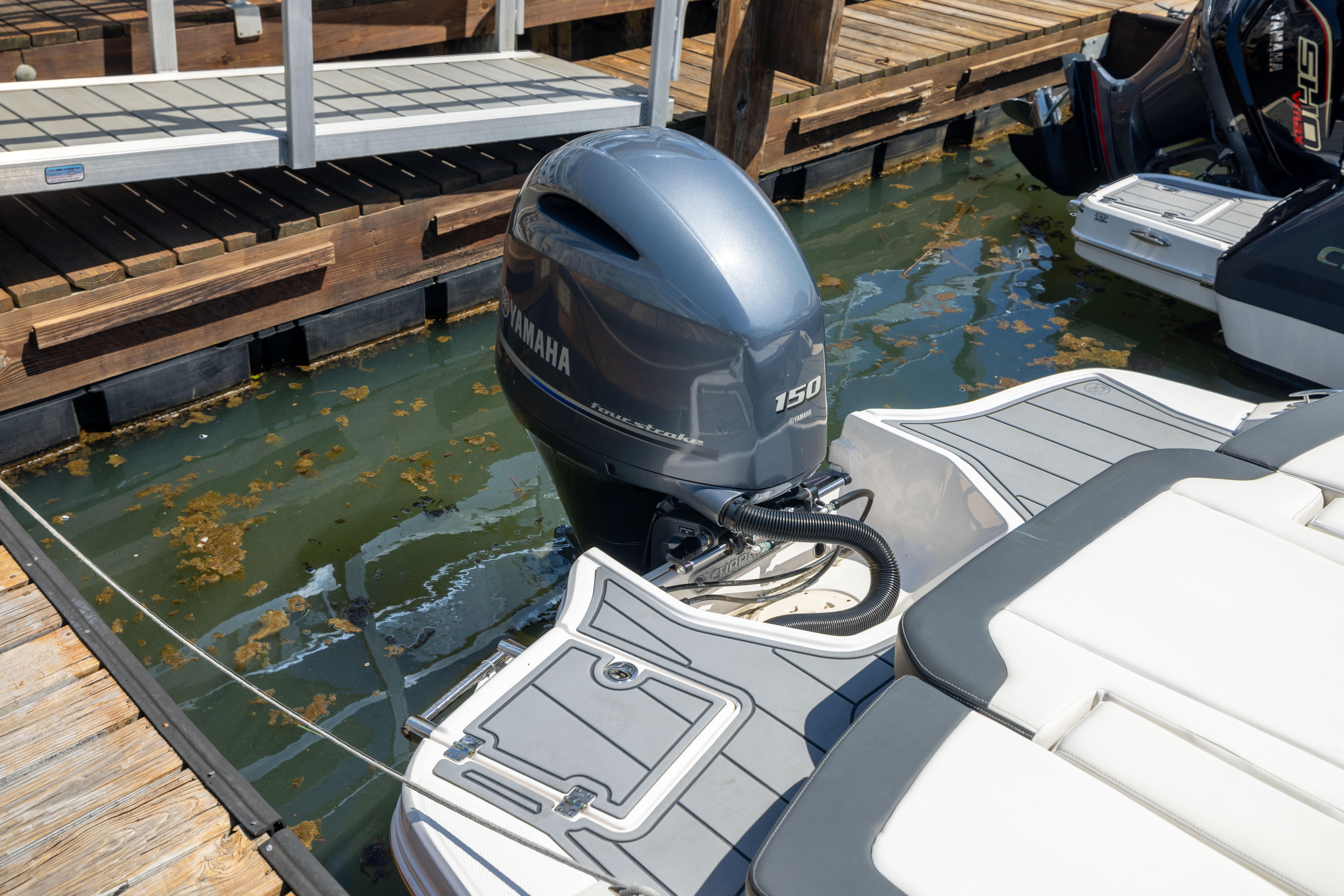 2022 Chaparral 21 SSi OB with Yamaha 150 outboard engine docked at marina.
