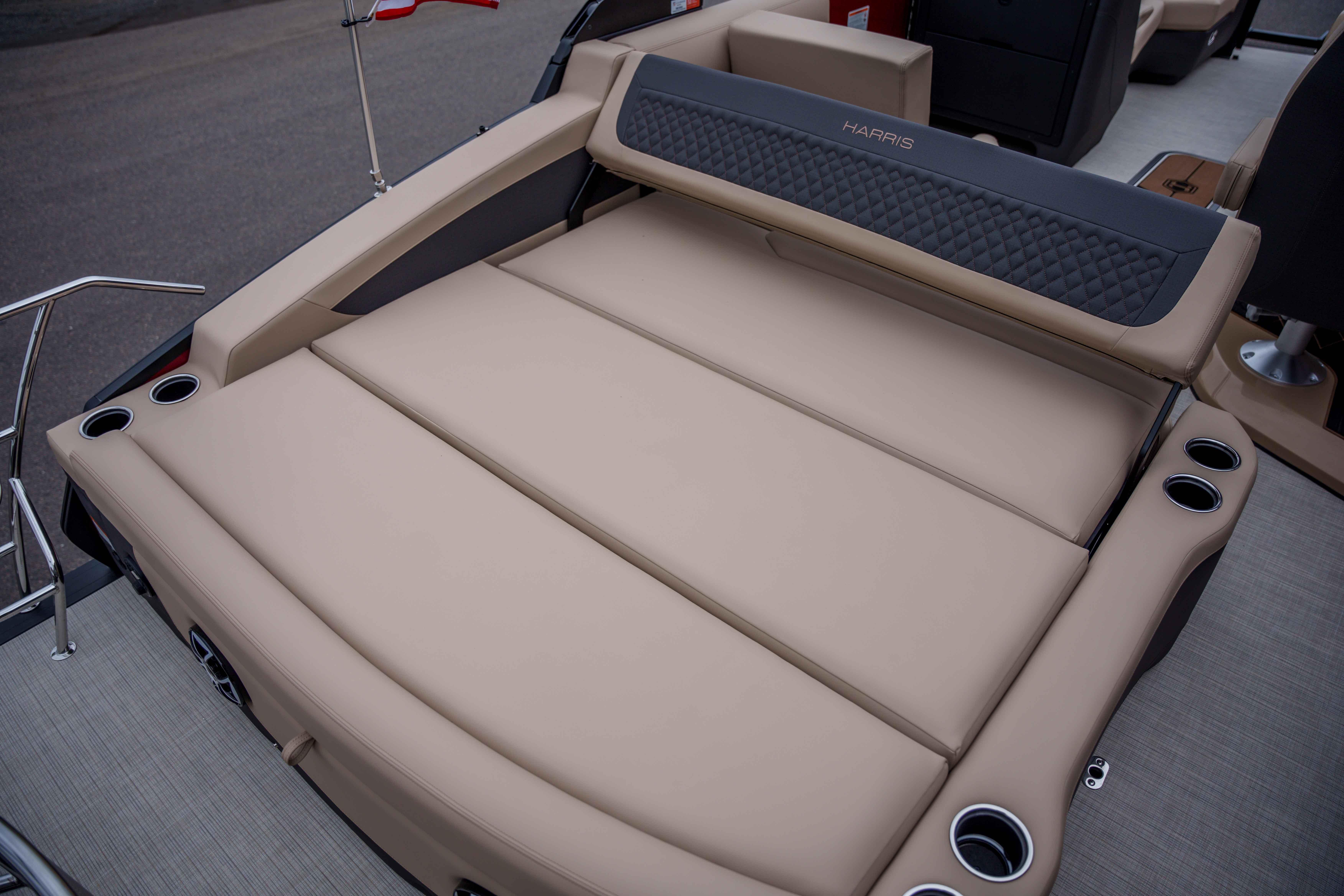 2026 Harris Sunliner 230 boat with luxurious beige seating and integrated cup holders.