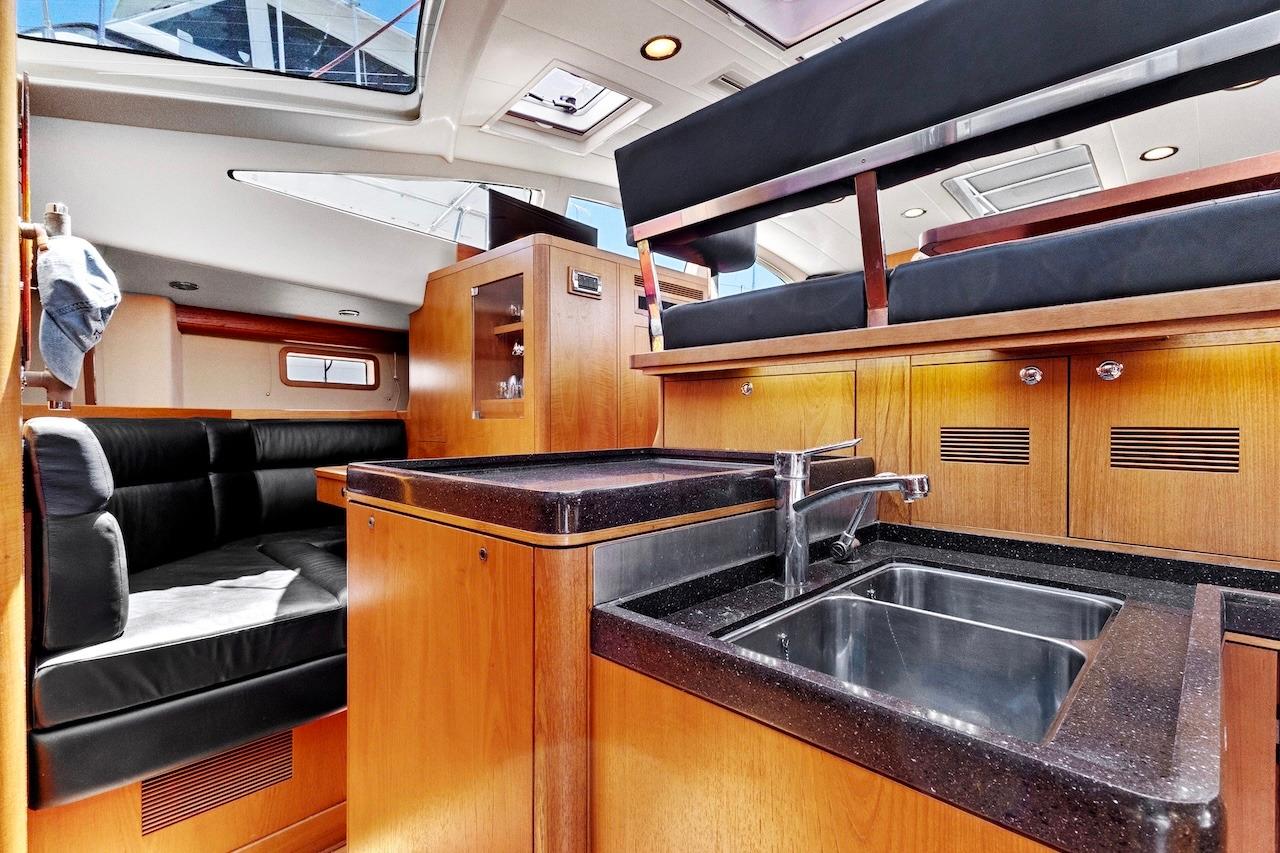 Luxurious interior of 2011 Southerly 57 RS yacht with modern kitchen and seating area.