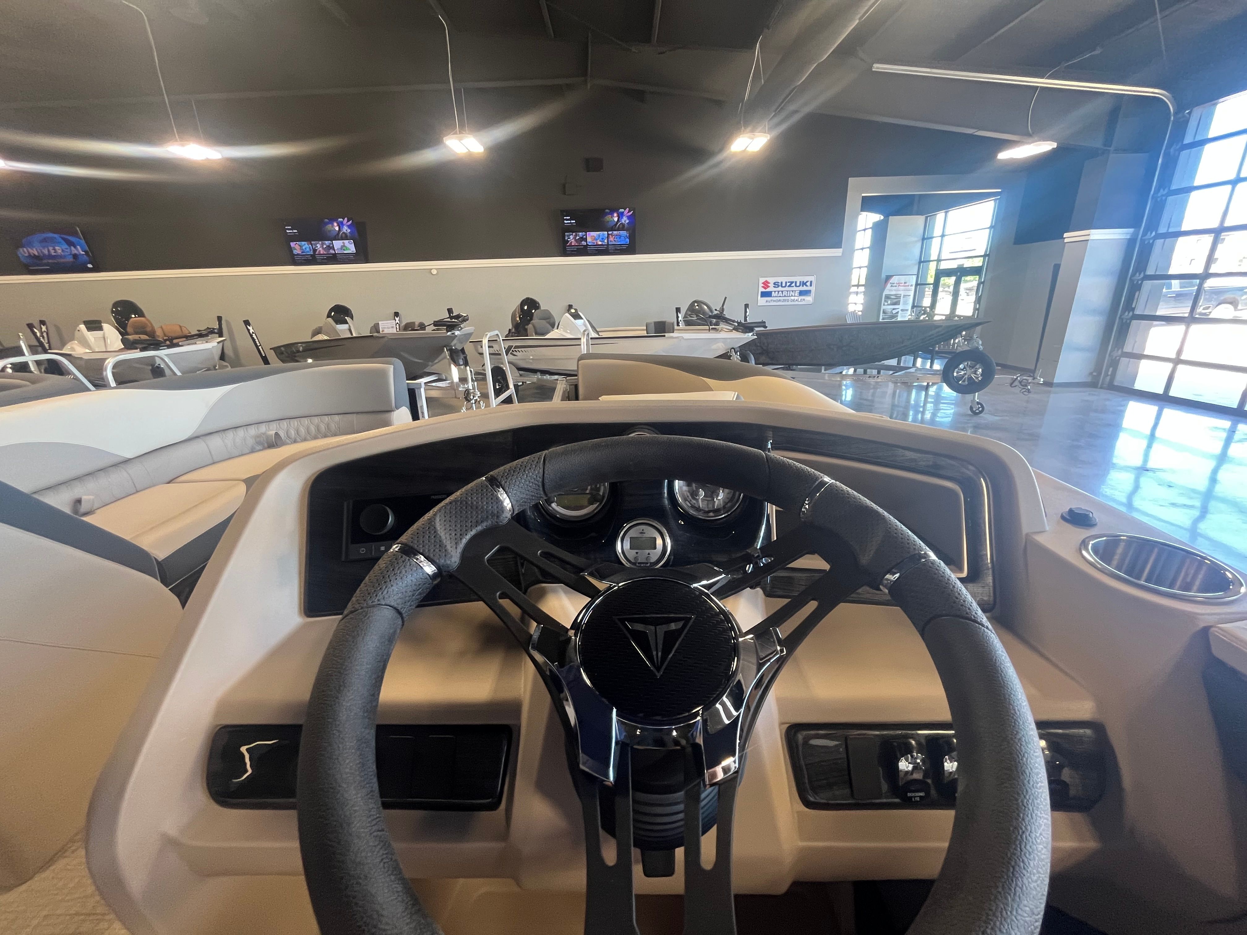 Interior view of 2025 Tahoe LTZ QL boat in showroom.