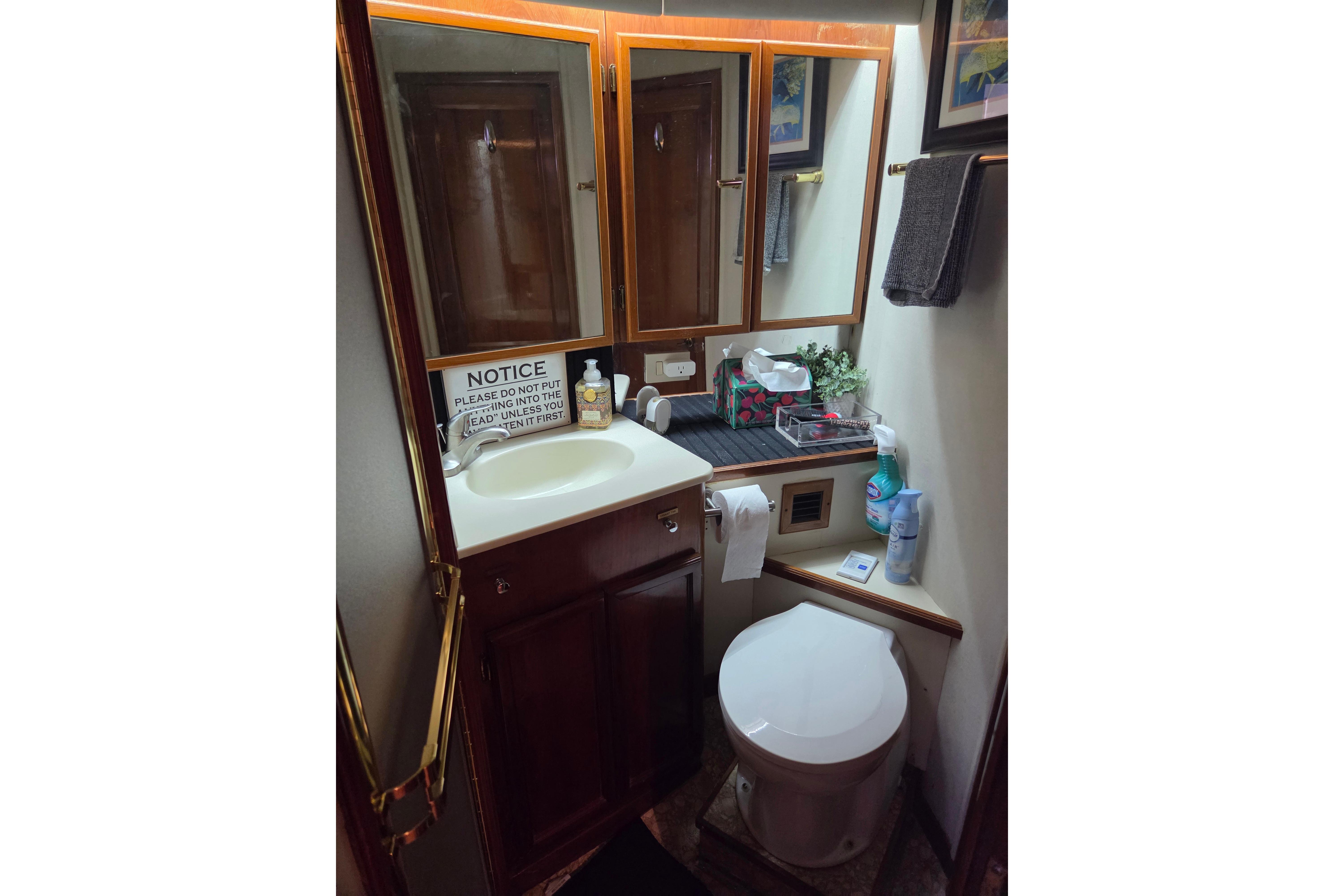 Bathroom interior of 1990 Egg Harbor Golden Egg 42 yacht, featuring sink and toilet.