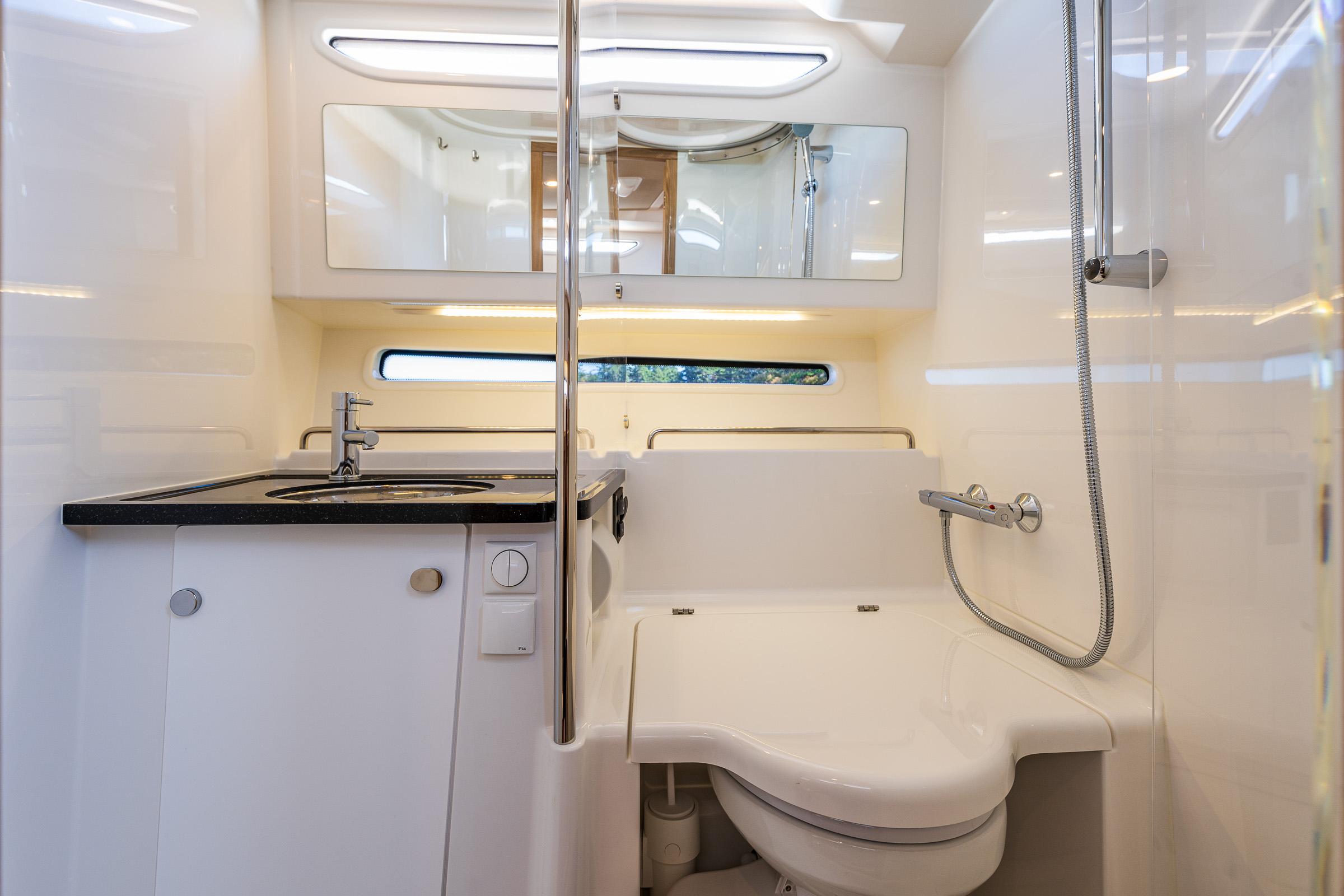Modern bathroom interior in 2025 Nimbus W11 yacht, featuring sleek design and compact amenities.