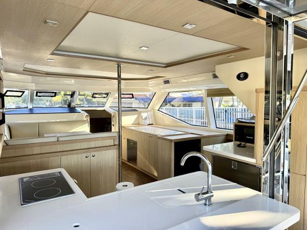 Luxurious interior of 2022 Aquila 44 yacht with modern kitchen and seating area.