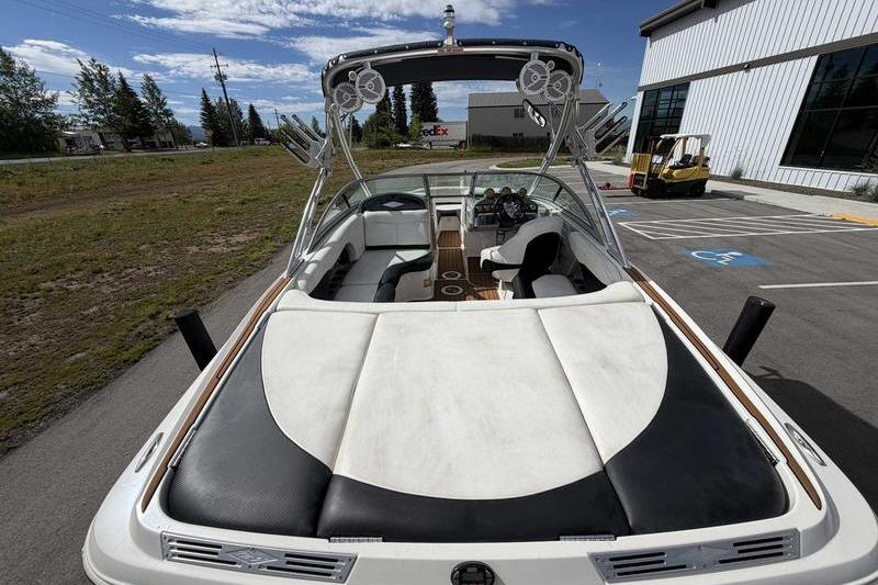 2004 MasterCraft XStar boat with sleek interior and wakeboard tower, parked outdoors.