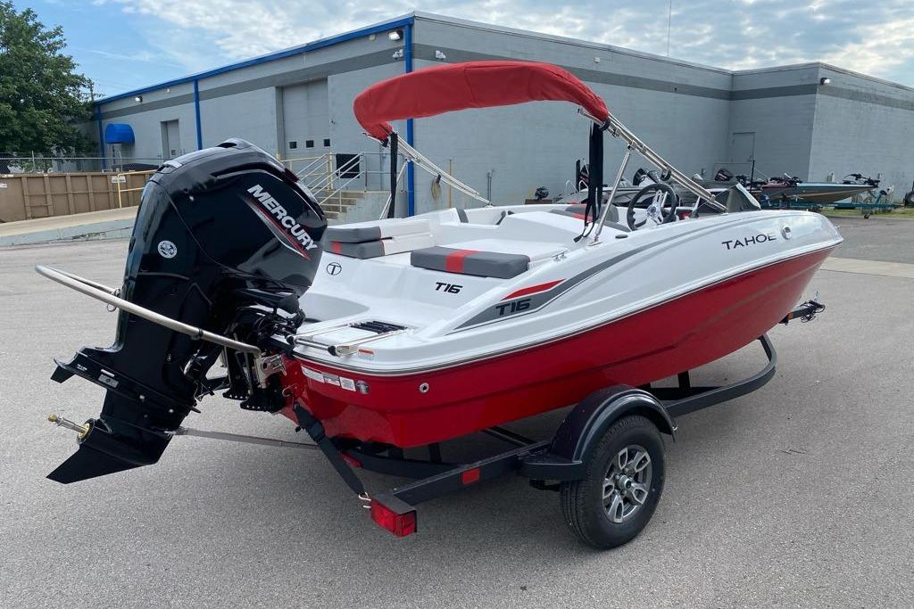 2026 Tahoe T16 boat with Mercury engine, red and white design, parked on trailer.