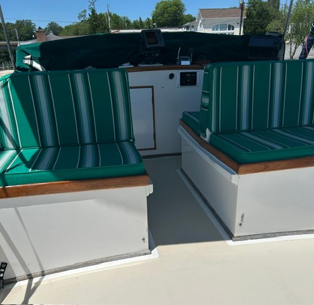 Interior of a 1980 Grand Banks 32 Sedan with green striped seating.