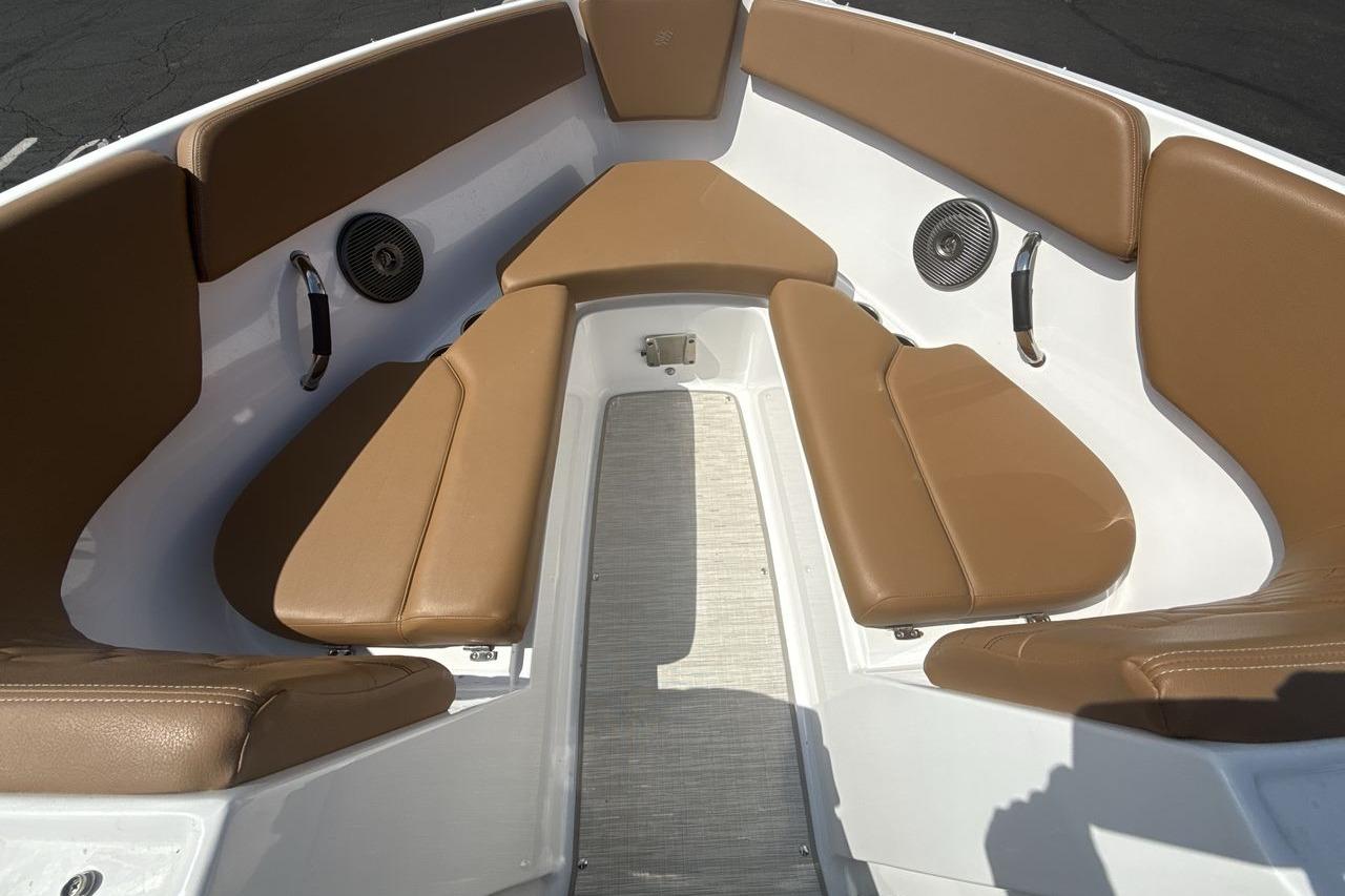 2024 Four Winns H1 OB boat interior with tan seating and speakers.