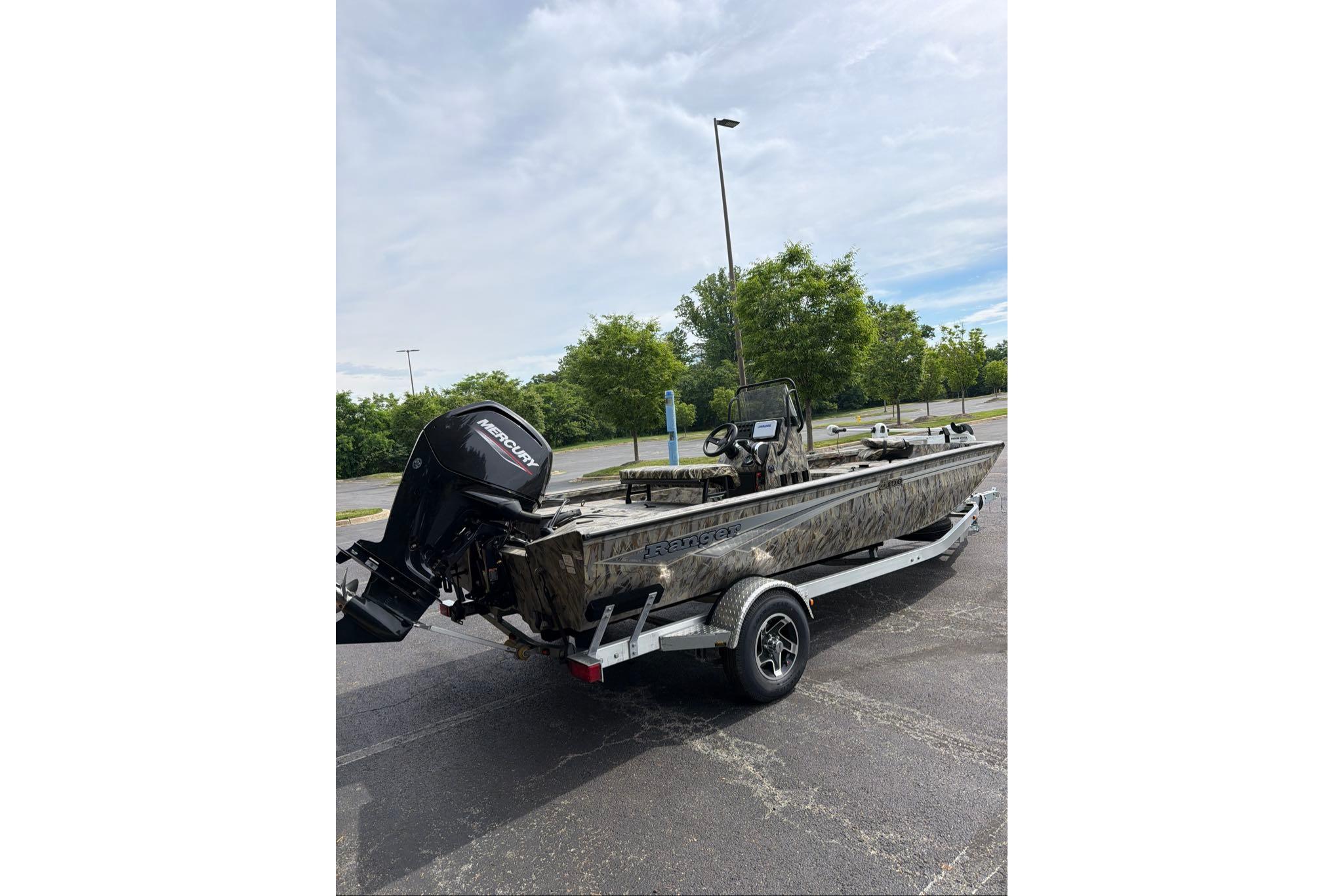 2026 Ranger RB190 boat with Mercury outboard motor on a trailer in a parking lot.