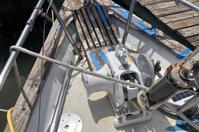 1979 Pearson 365 Ketch sailboat deck with anchor windlass and mooring lines.