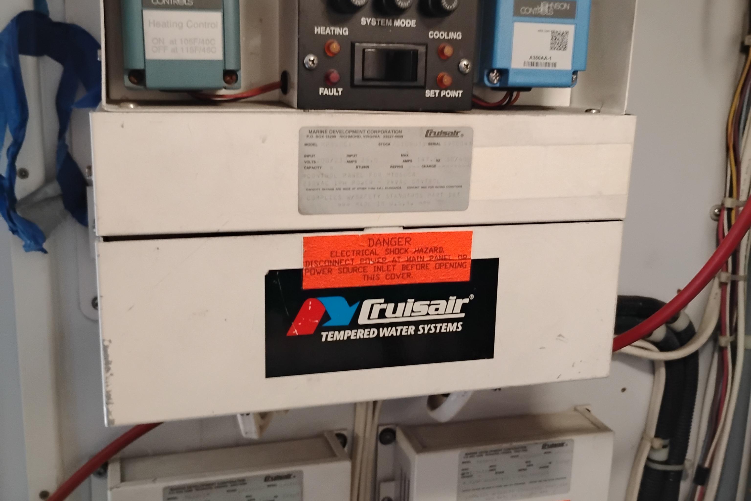 Electrical control panel on 1995 Queenship 62 Pilothouse Motor Yacht with warning labels.