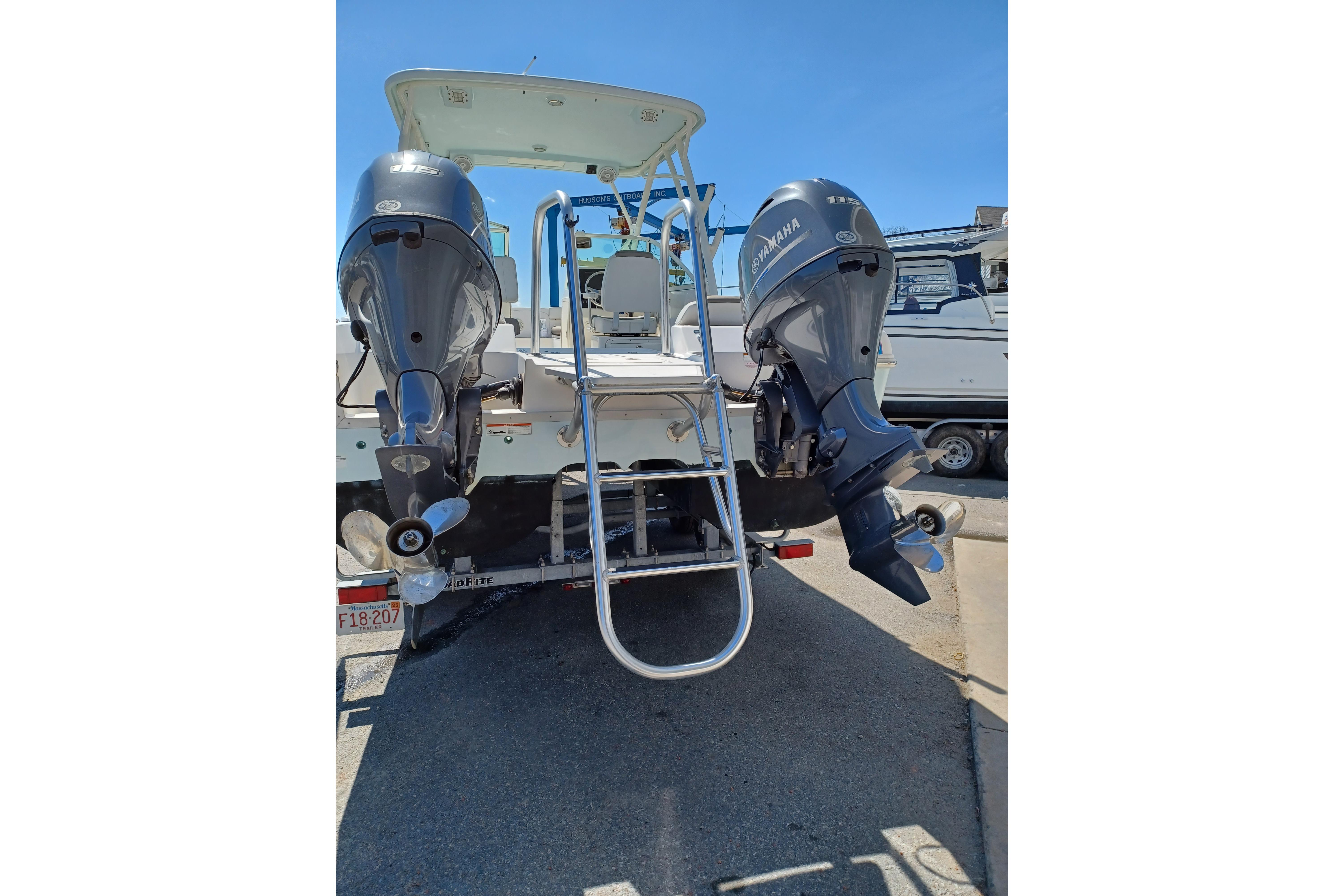2020 World Cat 230 DC boat with dual Yamaha outboard motors and ladder.
