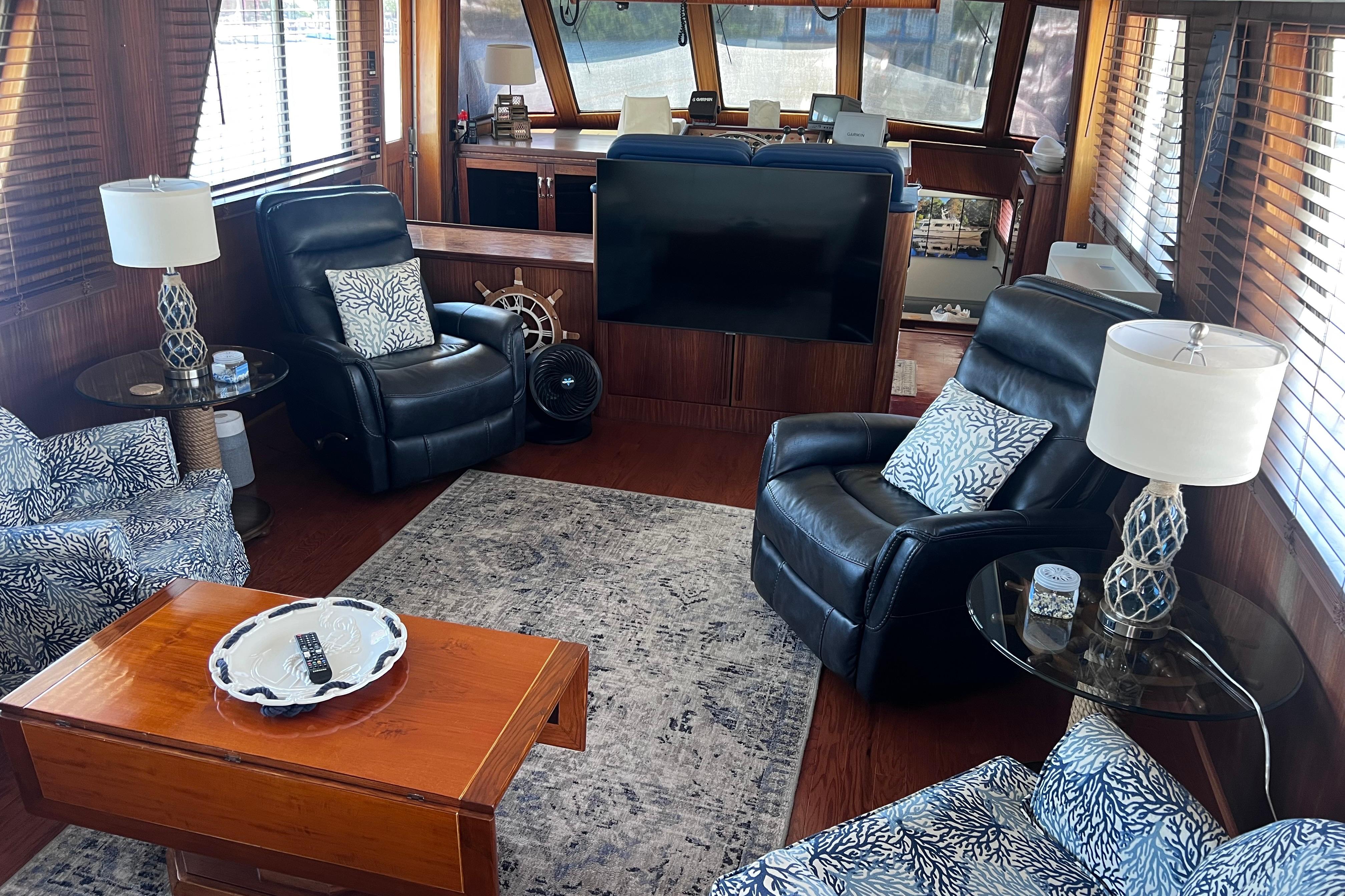 Luxurious interior of 1987 Hatteras 70 Cockpit Motor Yacht with leather seating and elegant decor.