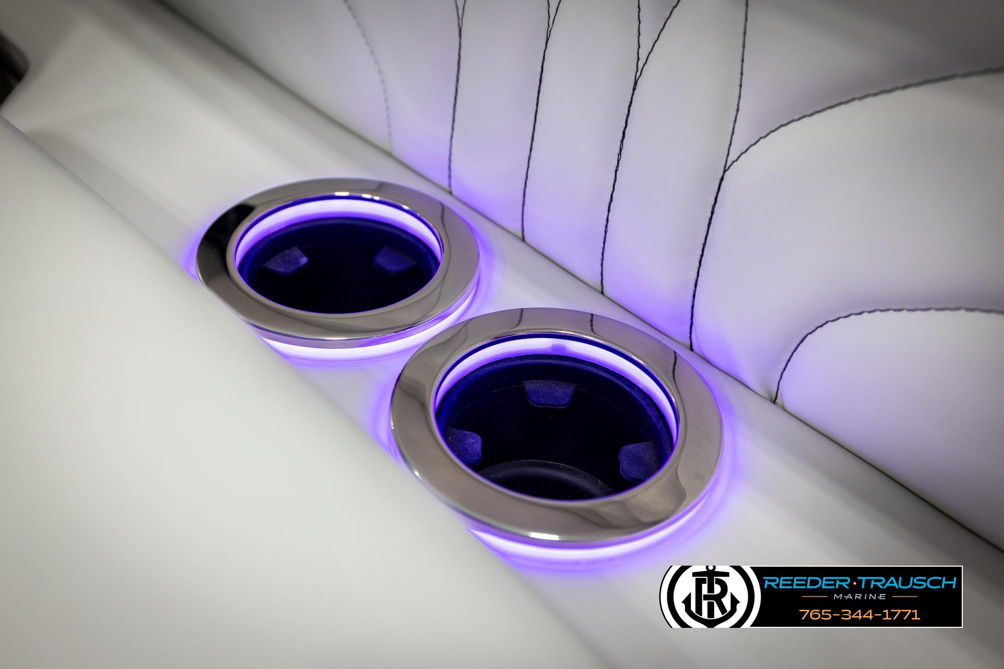 Illuminated cup holders in Avalon 2585 Excal VRBW boat, 2025 model, with sleek white upholstery.