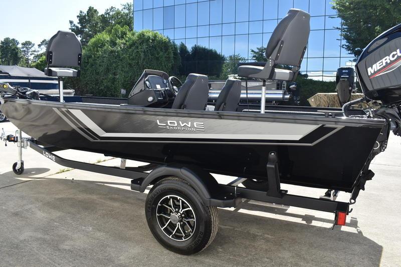 2026 Lowe Skorpion 17 boat on trailer, sleek design, parked outdoors.