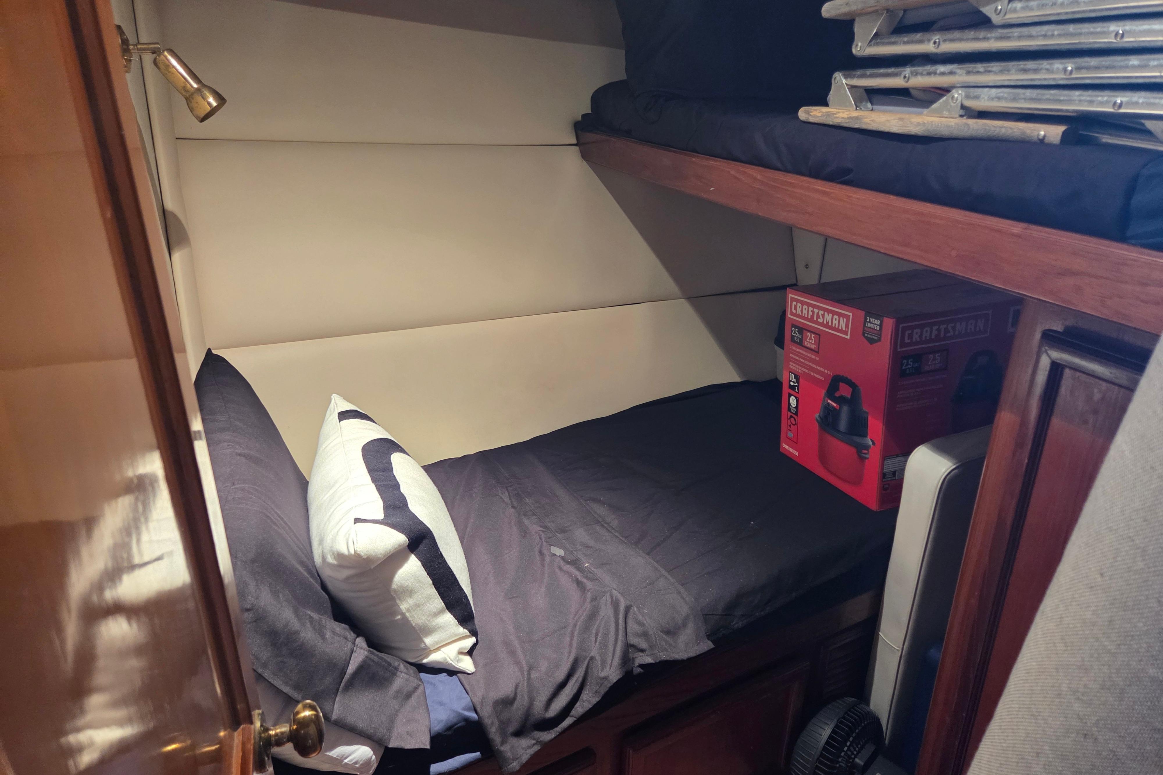 Cozy cabin interior of 1990 Egg Harbor Golden Egg 42 yacht with bed and storage.