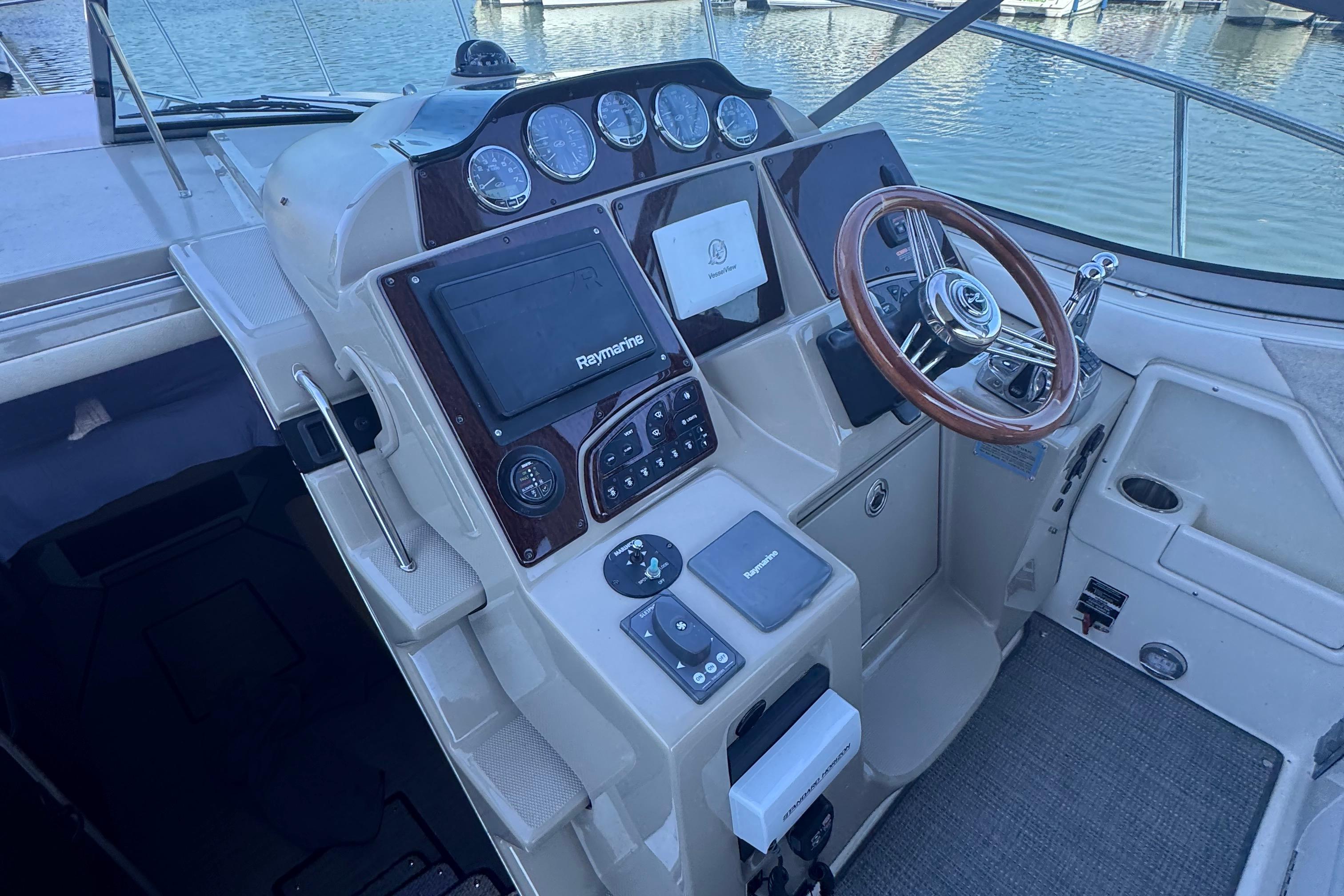 2008 Sea Ray 350 Sundancer helm with Raymarine electronics and wooden steering wheel.