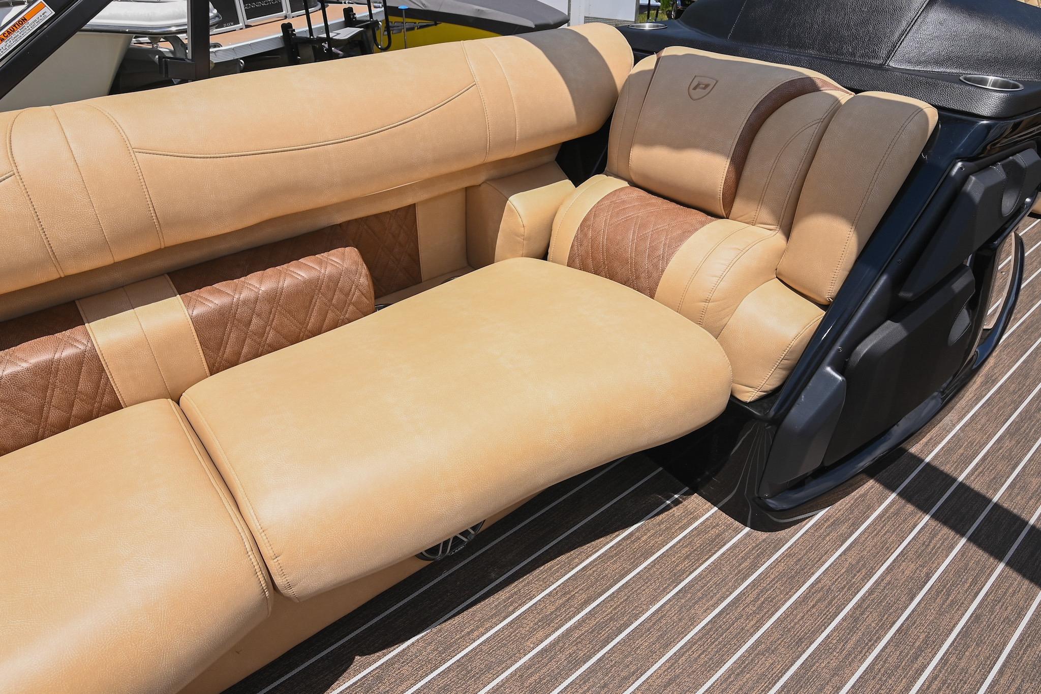 Luxurious seating on 2023 Premier 270 Intrigue RF boat with tan upholstery and elegant design.