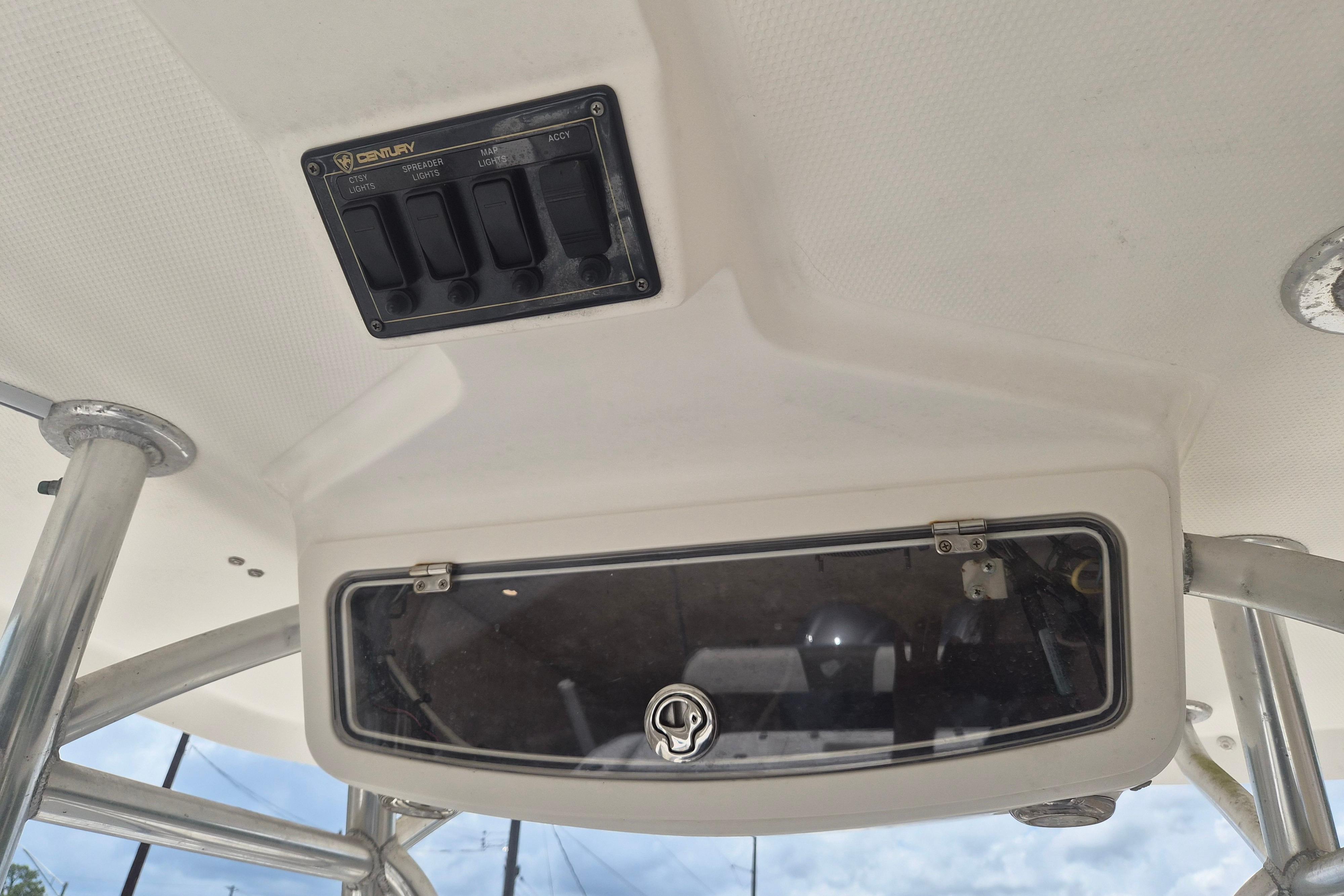 Century 2900 Center Console 2006 boat dashboard with control panel and storage compartment.