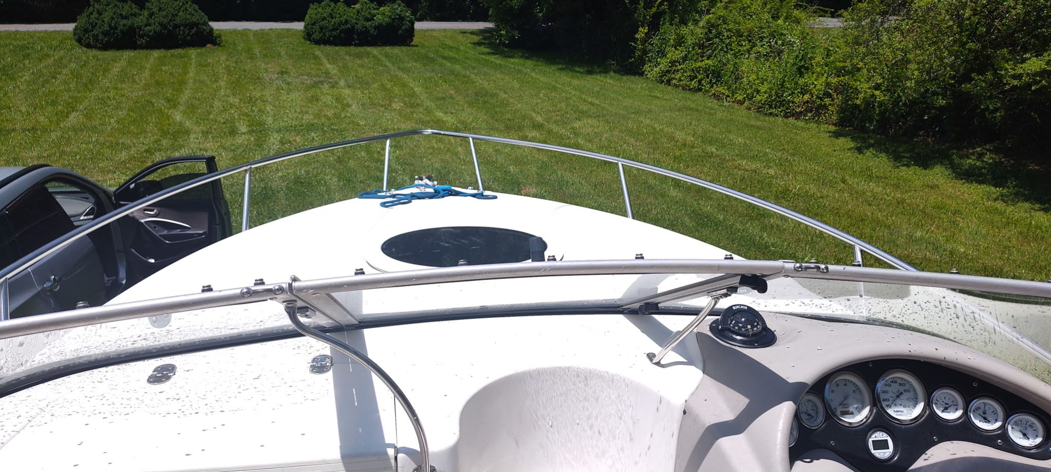 The image shows the deck of a 2002 Stingray 240 CR boat on a grassy area.