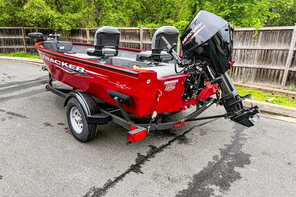 Red 2025 Tracker Super Guide V-16 T boat with Mercury outboard motor on trailer.