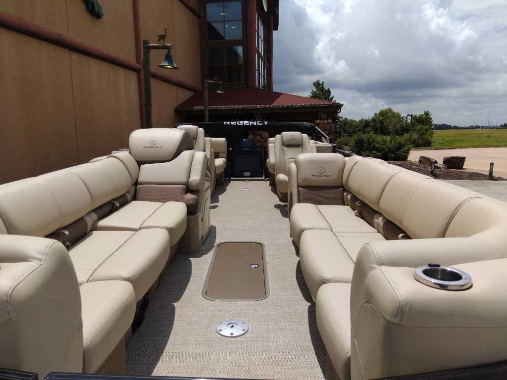 2025 Regency 250 LE3 pontoon boat with luxurious beige seating and spacious deck.