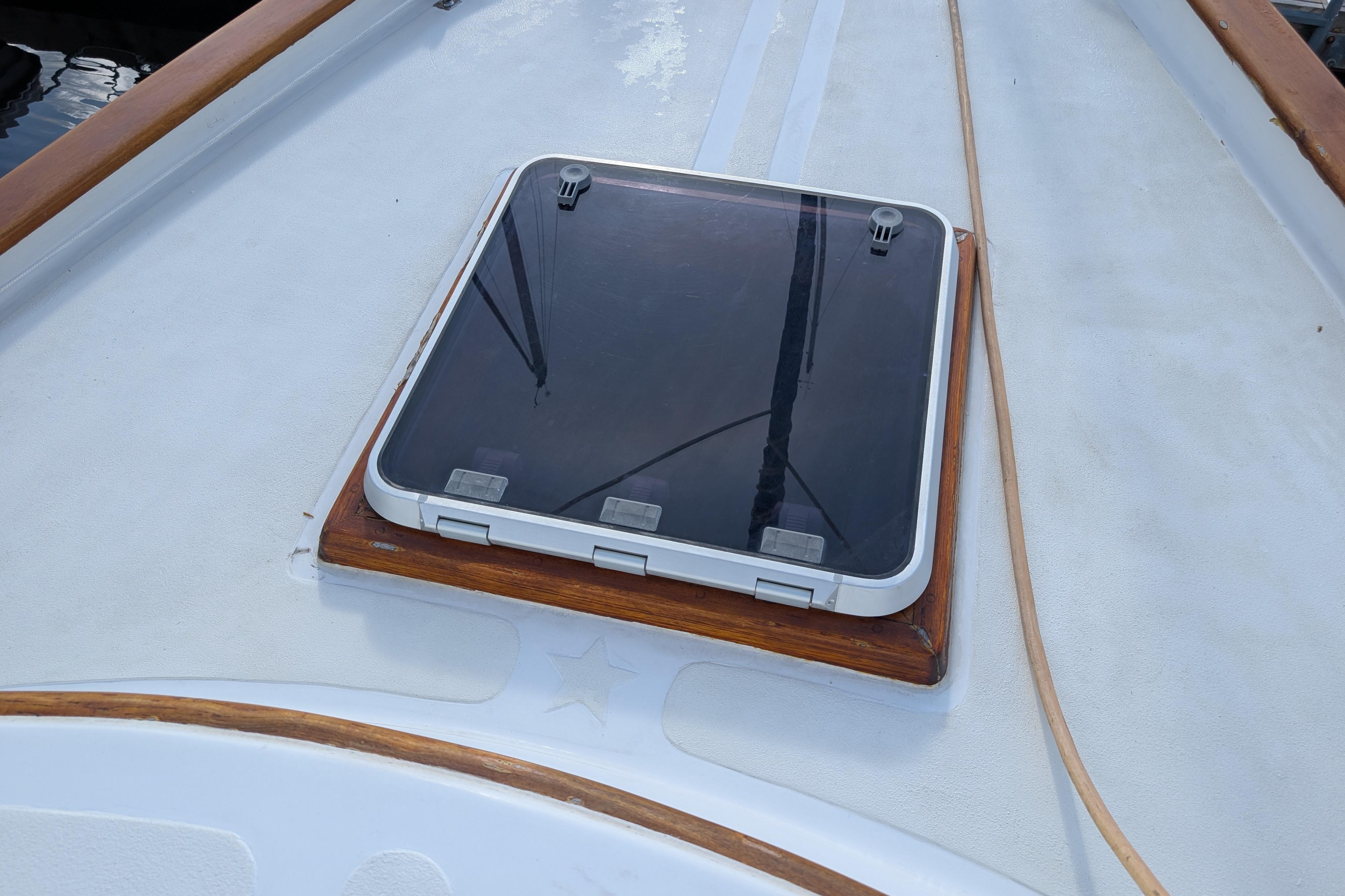 Hatch on deck of 1983 Robert Perry 41 sailboat, featuring wooden trim.
