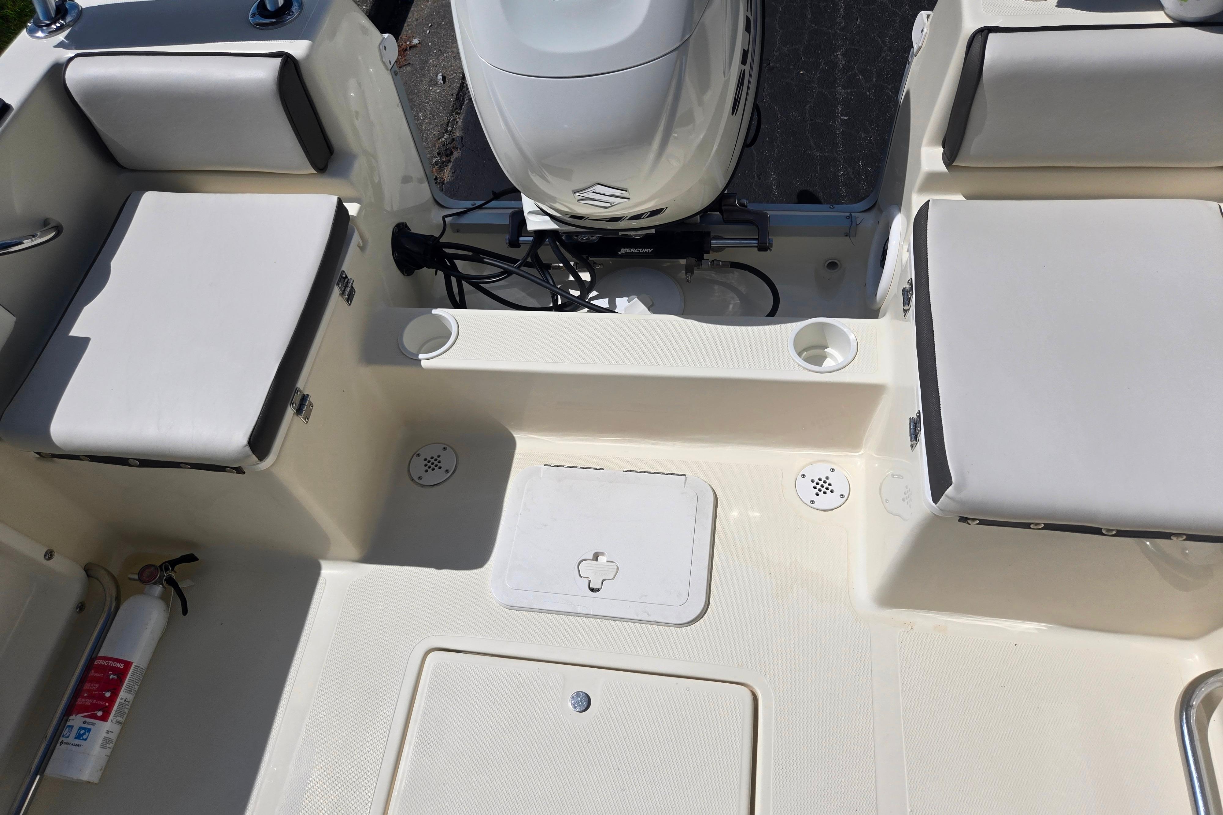 Interior view of a 2016 Key Largo 2000CC boat with seating and motor.