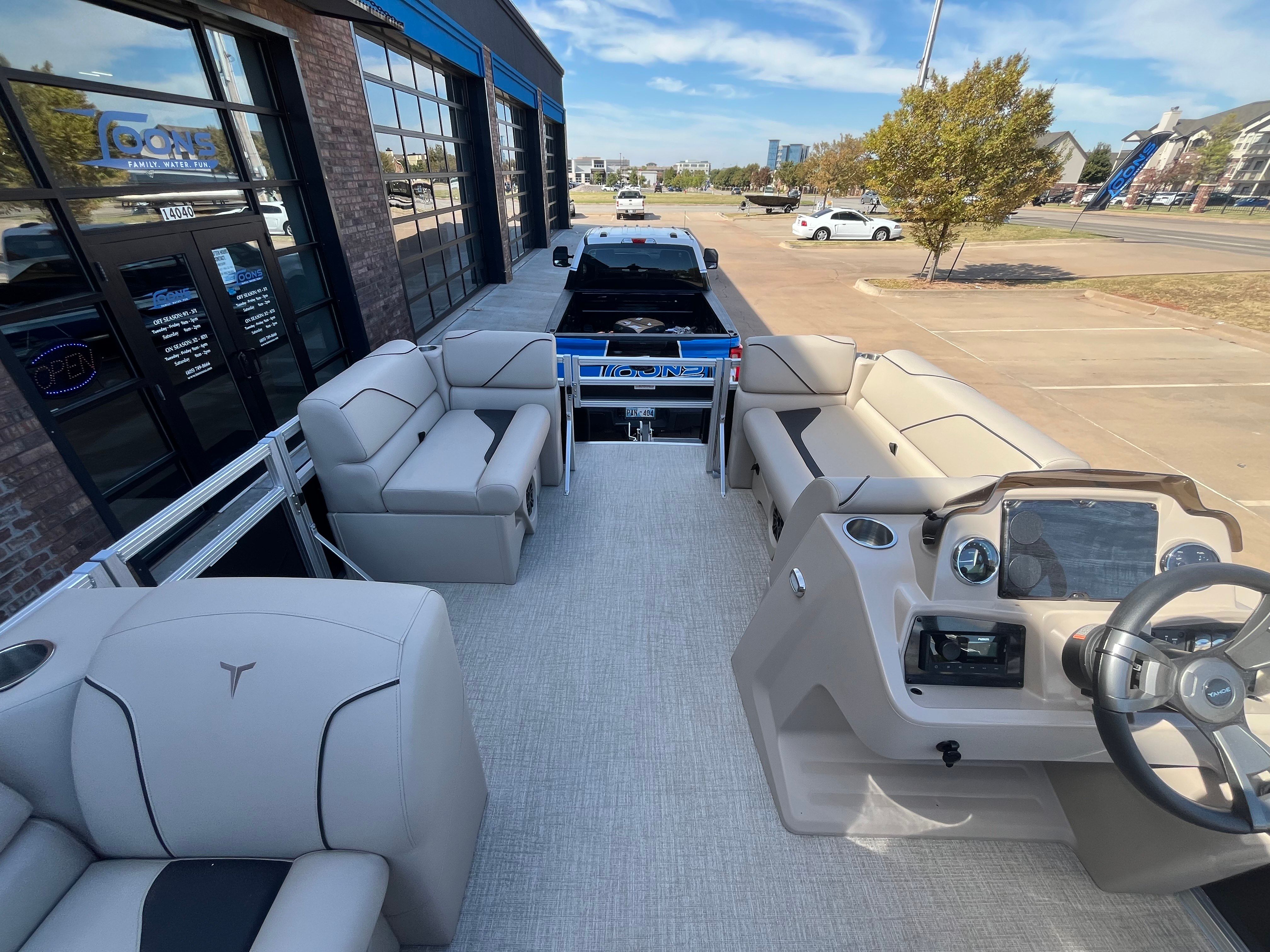 2026 Tahoe 1925 Sport Rear Fish pontoon boat parked outdoors.