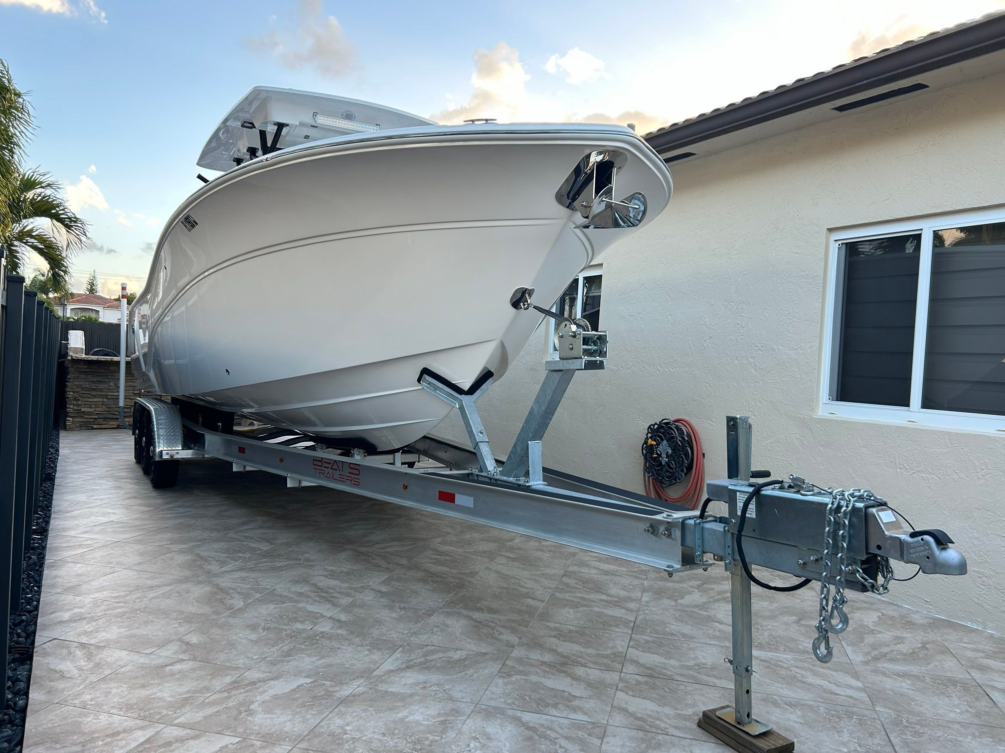 A 2023 Sea Fox 288 Commander on a trailer beside a building.