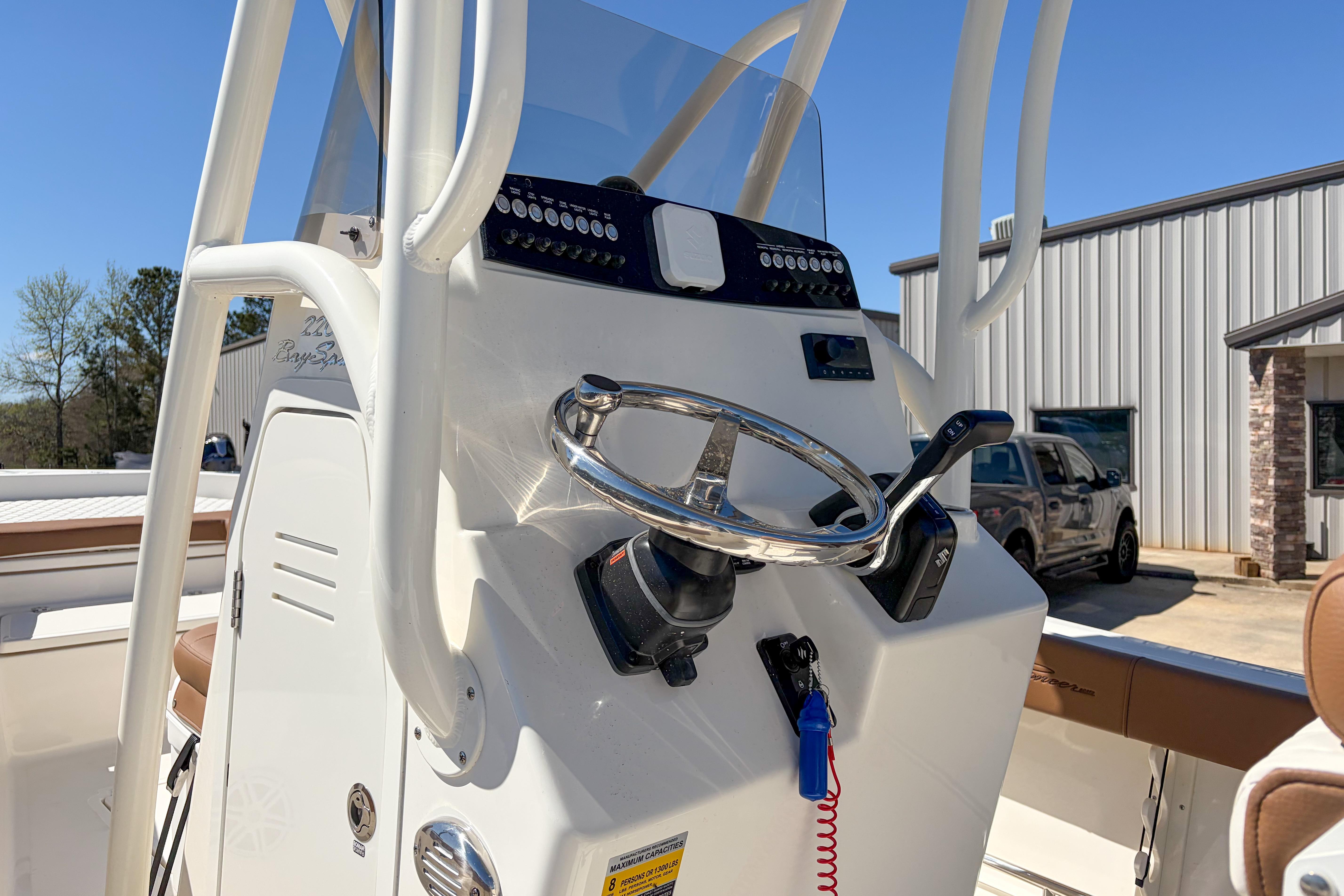2026 Pioneer 220 Bay Sport boat console with steering wheel and controls.