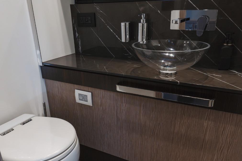 Luxury yacht bathroom with glass sink and modern fixtures, Azimut 60, 2020 model.
