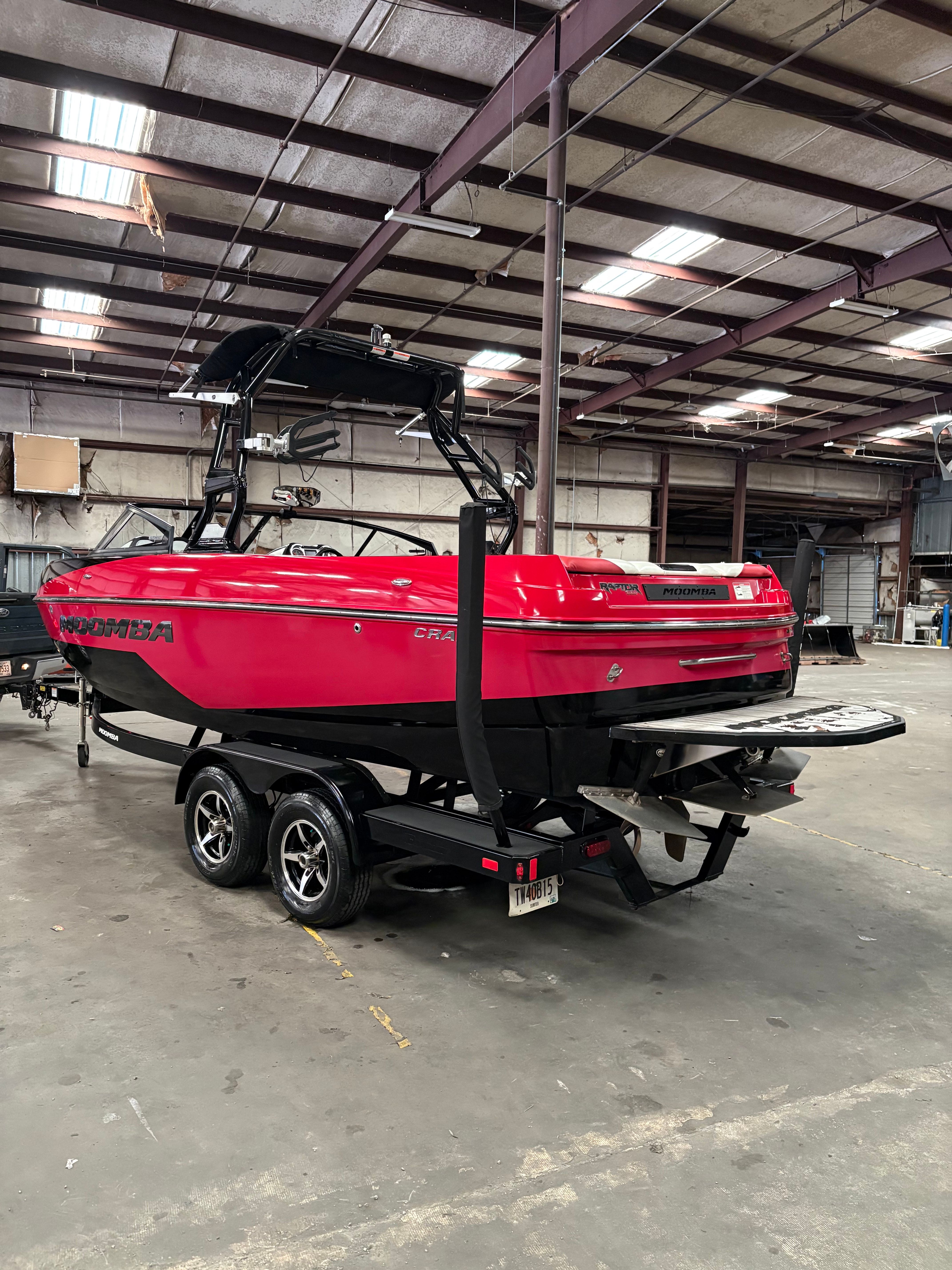 Red 2019 Moomba Craz boat in a warehouse.