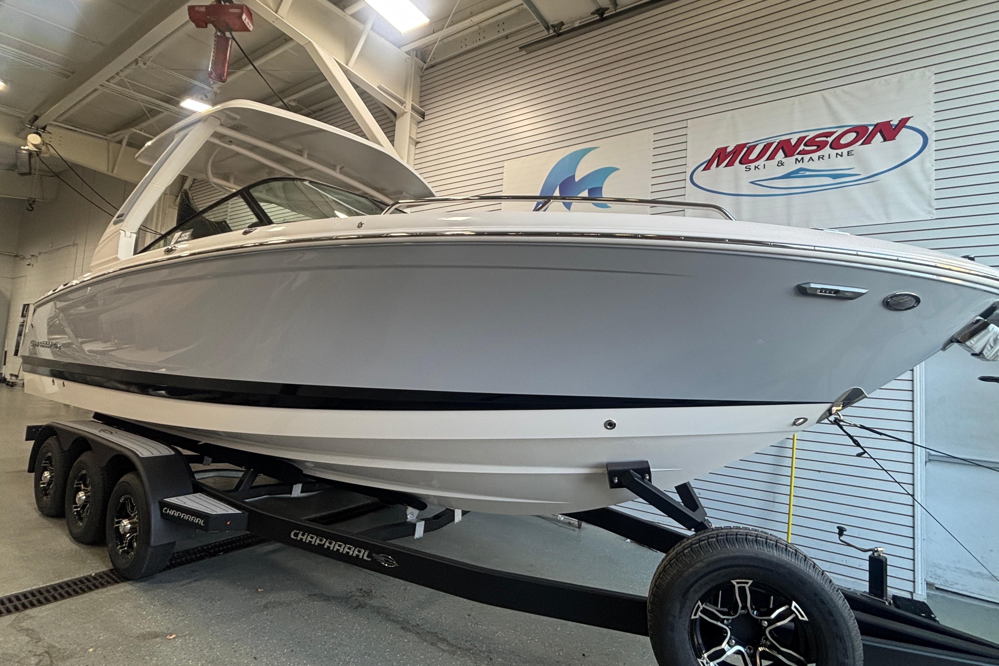 2026 Chaparral SSX 30 boat on trailer in showroom, Munson Ski & Marine banner visible.