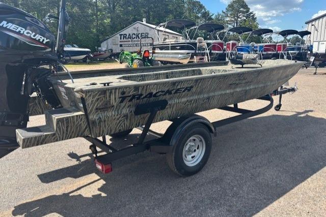 2026 Tracker Grizzly 1654 T Sportsman boat on trailer, parked outdoors.