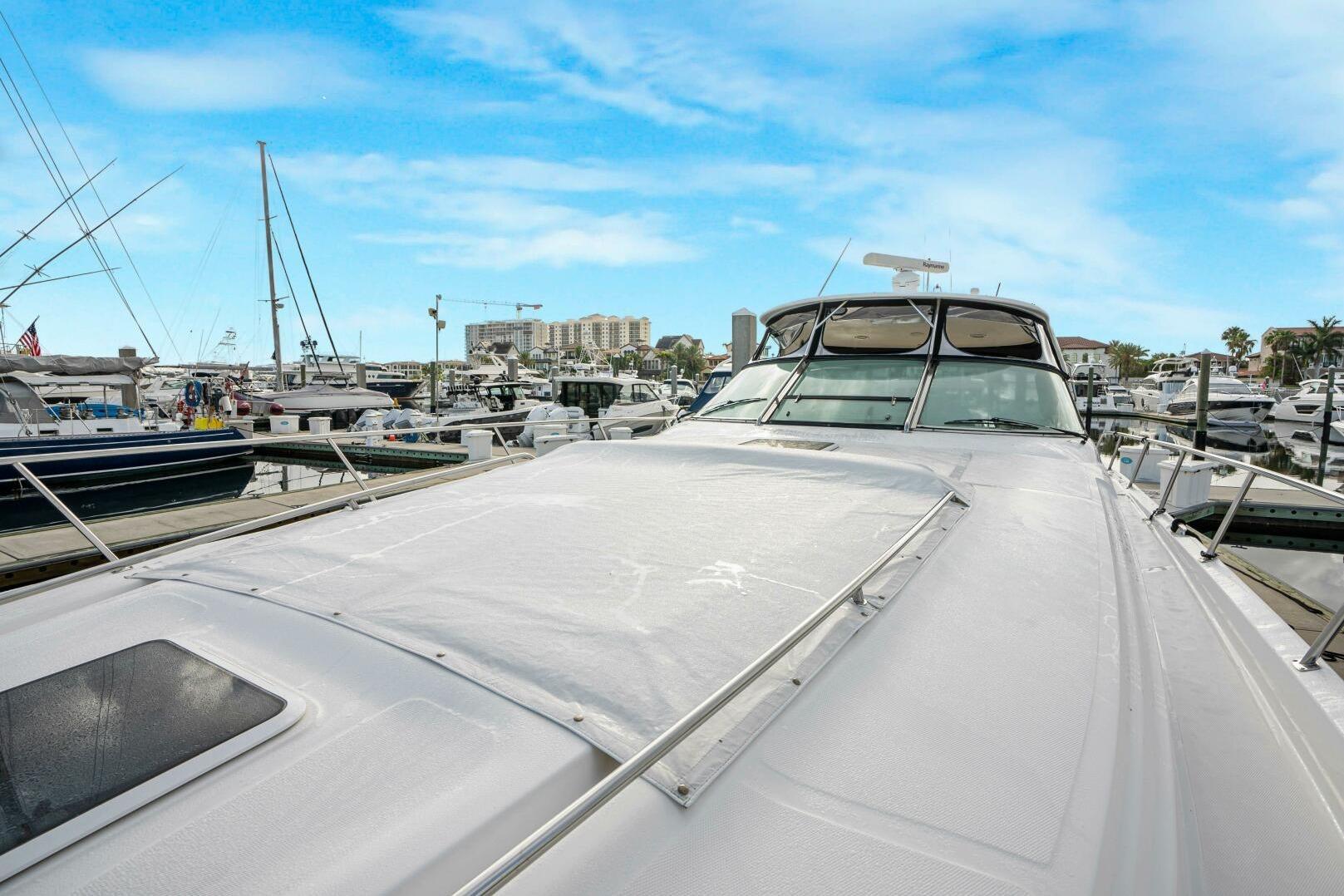 2003 Sea Ray Sundancer 460 yacht docked at a marina under a clear blue sky.