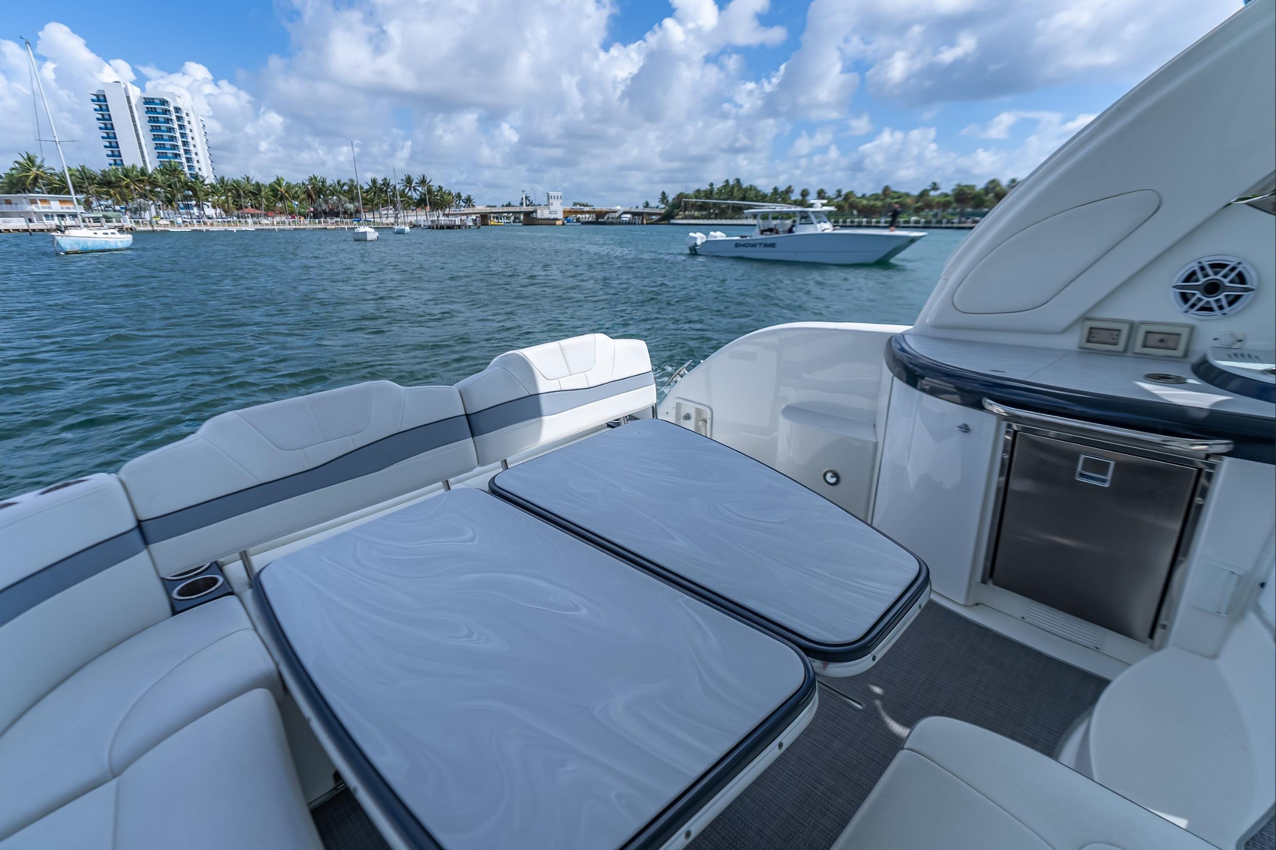 2022 Formula 40 Performance Cruiser, luxurious deck view, docked near palm-lined shore.