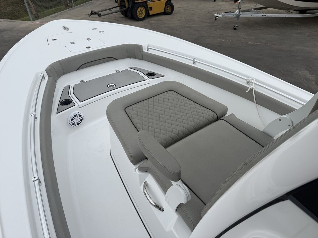 The image shows the cockpit of a Sportsman Masters 247OE Bay Boat with gray upholstery.