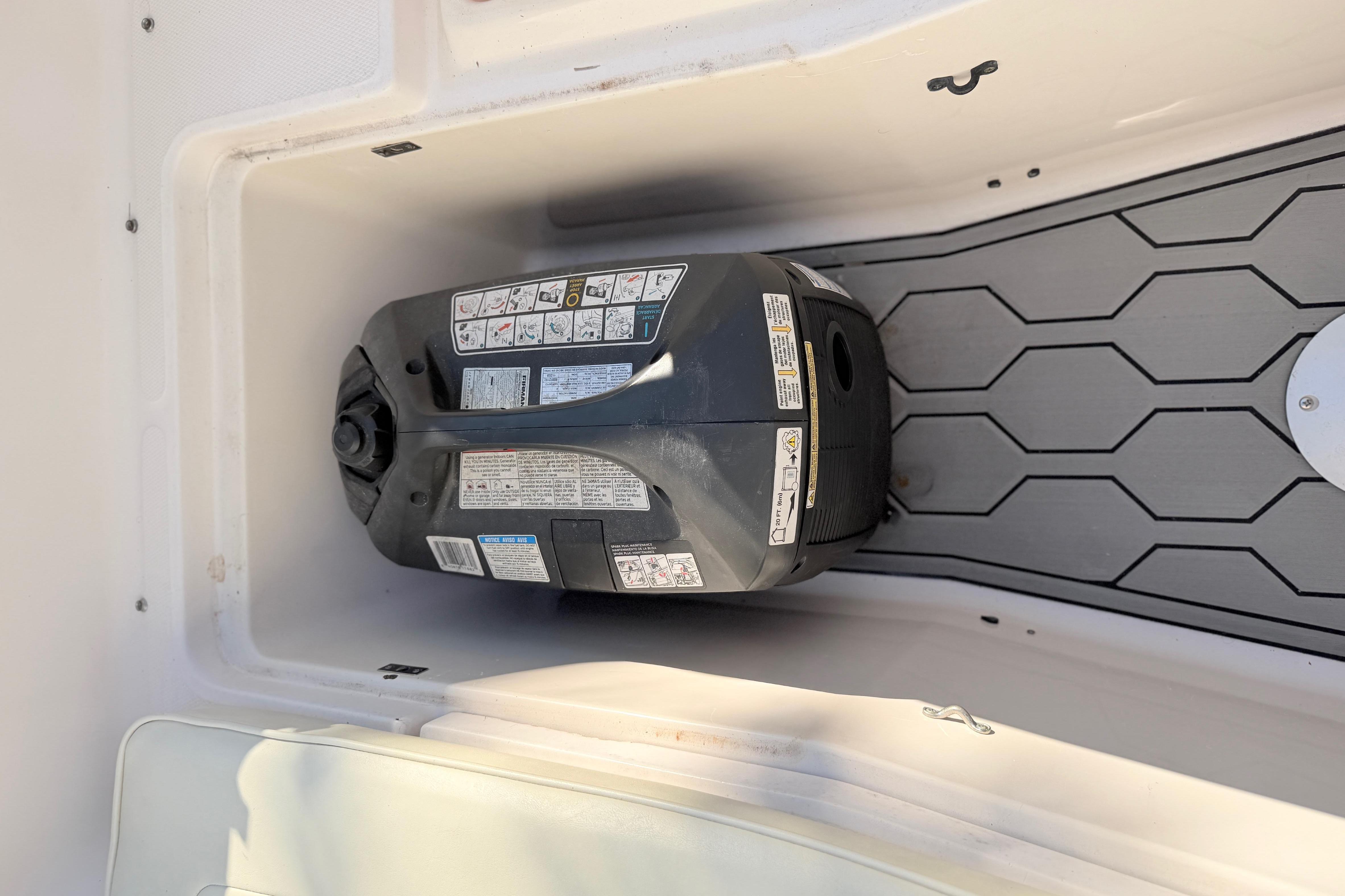 Storage compartment in a 2004 Grady White 273 boat with equipment inside.