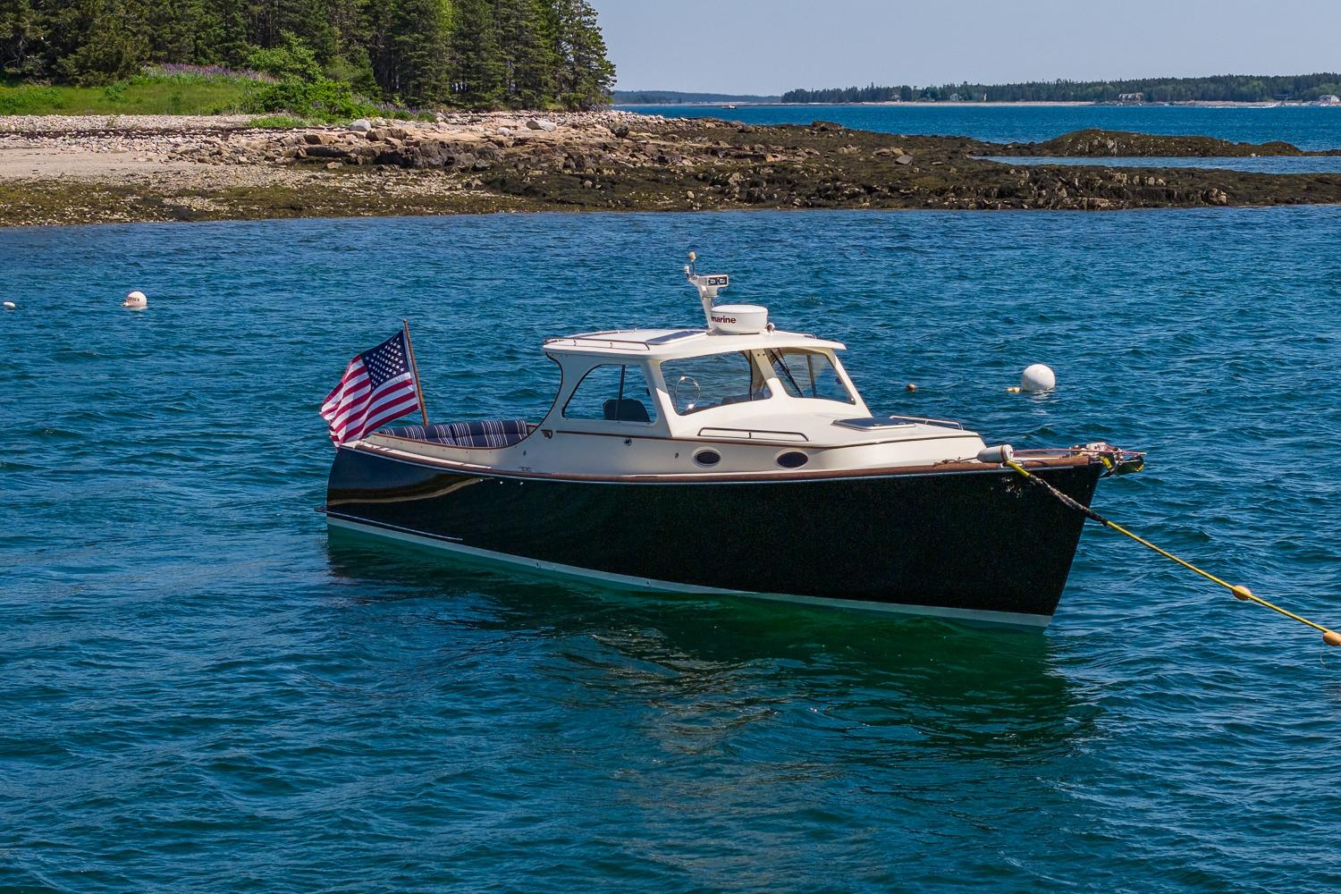 2001 Hinckley Picnic Boat 36 Classic anchored in scenic coastal waters.