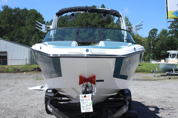 2025 MasterCraft NXT21 boat on trailer, front view, outdoors, sunny day.