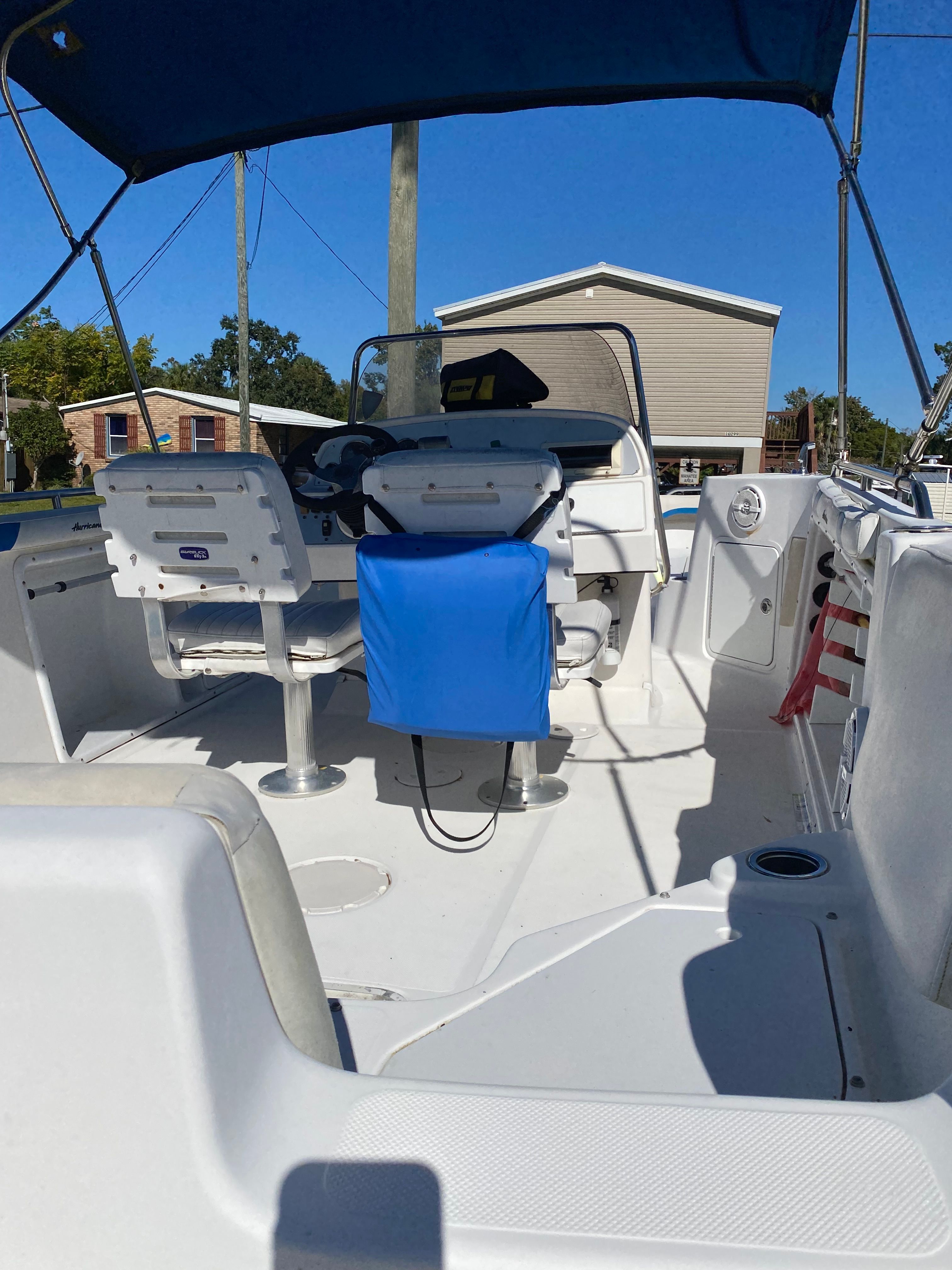 The image shows the cockpit of a 2012 Hurricane SunDeck Sport 231 OB boat.